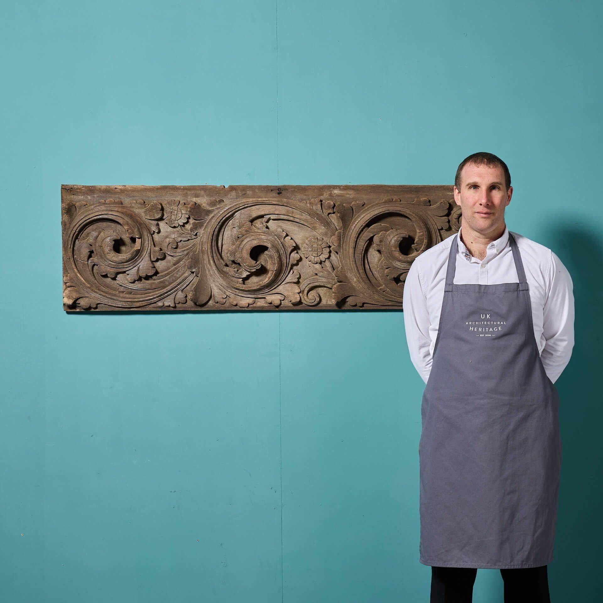 An antique English Tudor period oak panel dating to circa 1590, deeply handcarved with three large foliage scrolls and flowers. Over 430 years old, this oak wall panel has stood the test of time, today making a stunning architectural piece for an