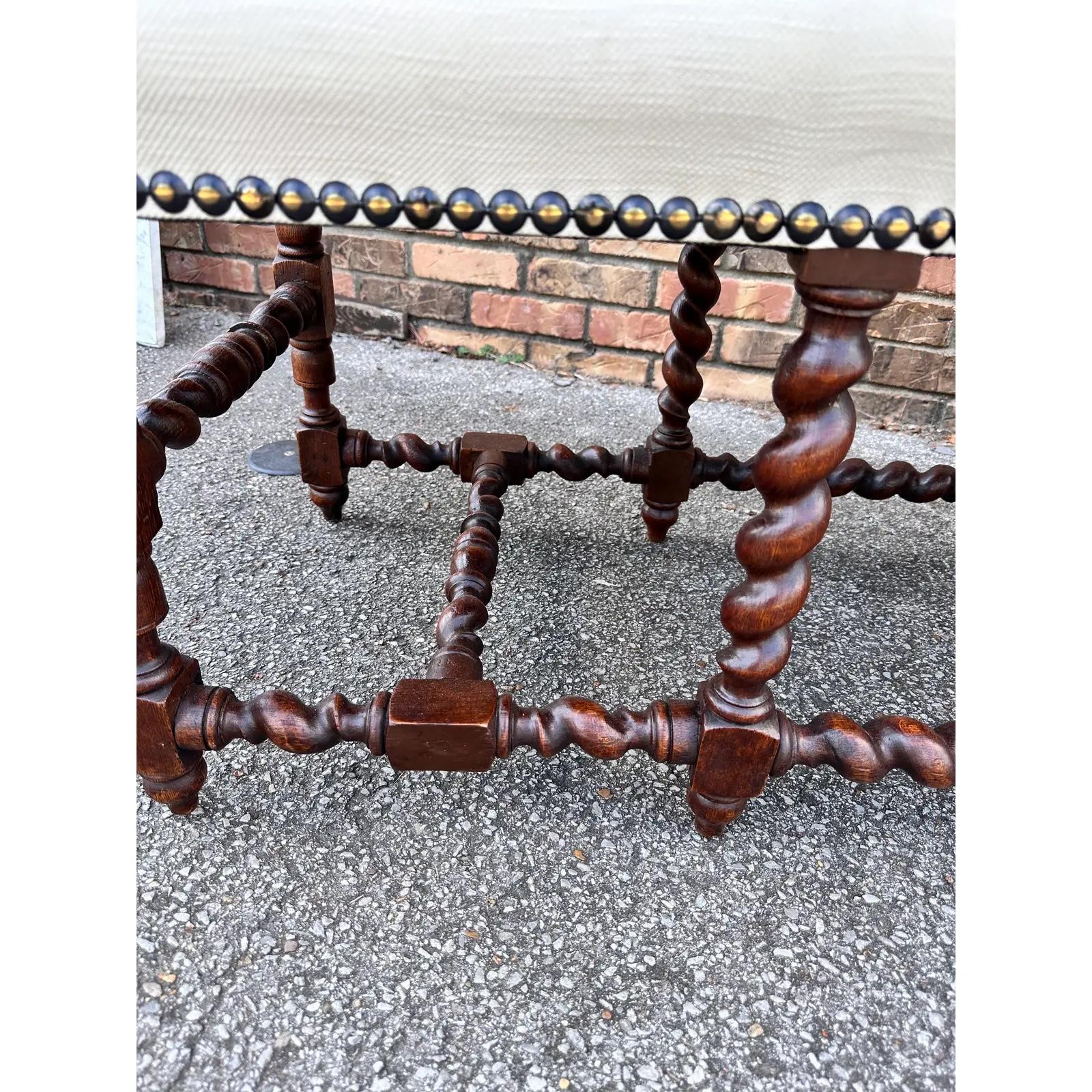 This is a beautifully Upholstered English bench the fabric is an off white or slight cream. The photo makes the benches appear whiter than they really are. However, it looks amazing paired with the dark wood. less. The barley twist legs really adds