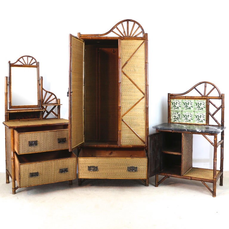 A rare three piece Victorian ‘Japanese’ bamboo and rattan bedroom suite dating to circa 1890. Comprising a wardrobe, dressing table and marble topped washstand each features a rising sun design to the top, bamboo frames and rattan panels. The
