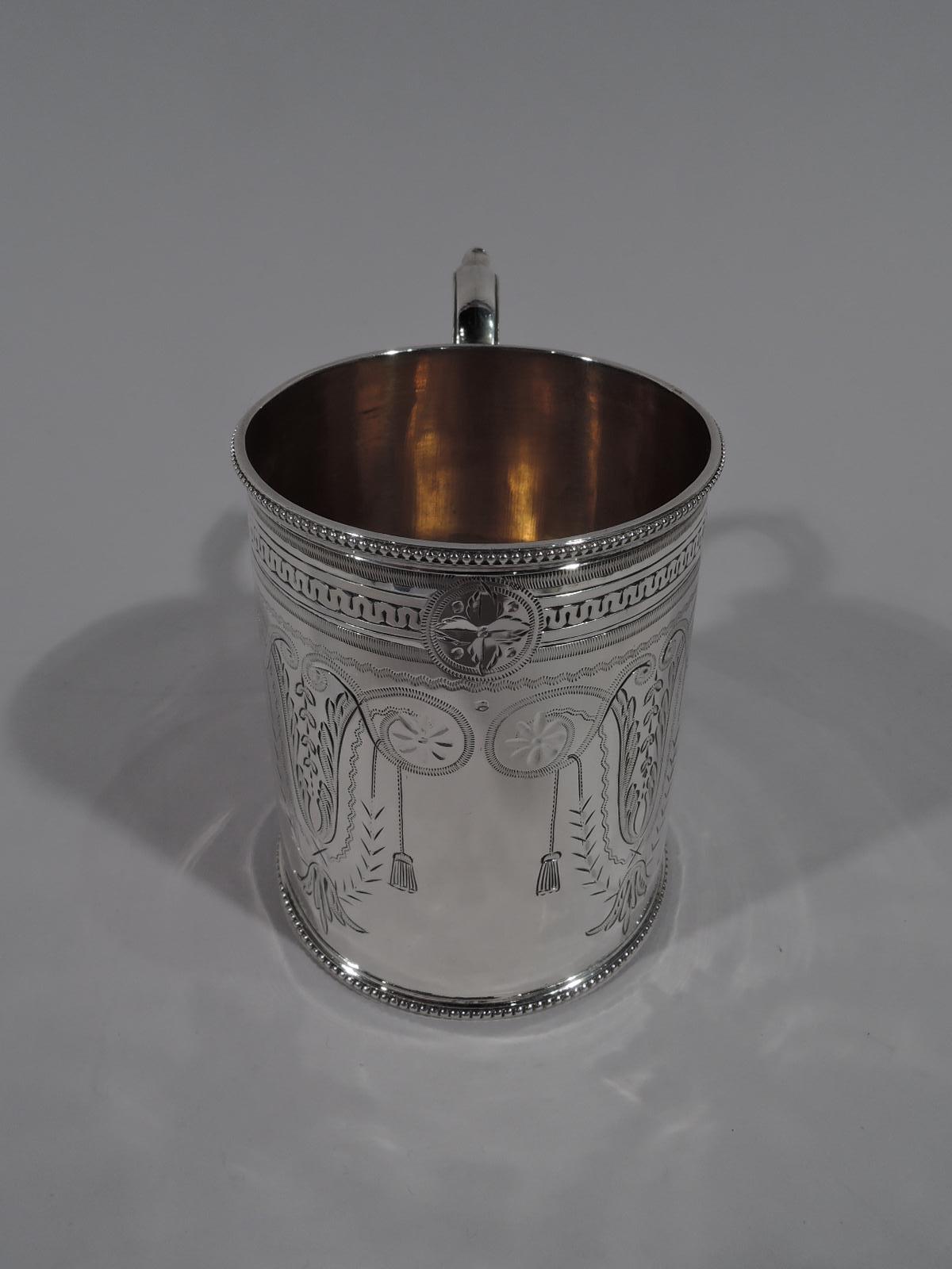 Victorian Aesthetic sterling silver baby cup. Made by Horace Woodward in Birmingham in 1879. Straight sides with capped and beaded S-scroll handle and beaded rims. Engraved stylized ornament with scrolls, leaves, paterae, and pendant flower heads. A