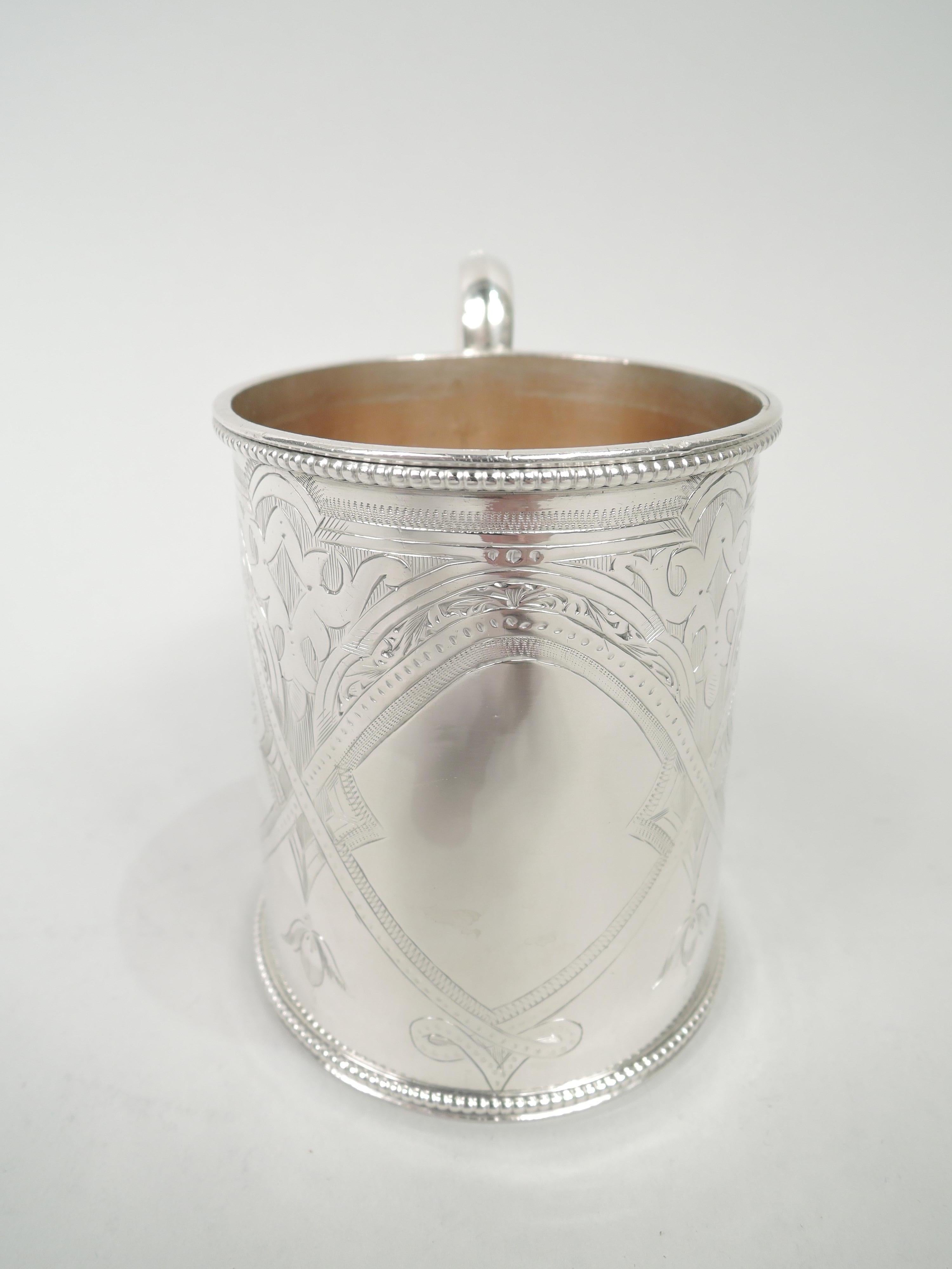 Victorian Aesthetic sterling silver baby cup. Made by George Fisher In London in 1871. Straight and upward tapering sides. High-looping and capped double c-scroll handle. Engraved stylized ornament: Three pointille strapwork frames of which two