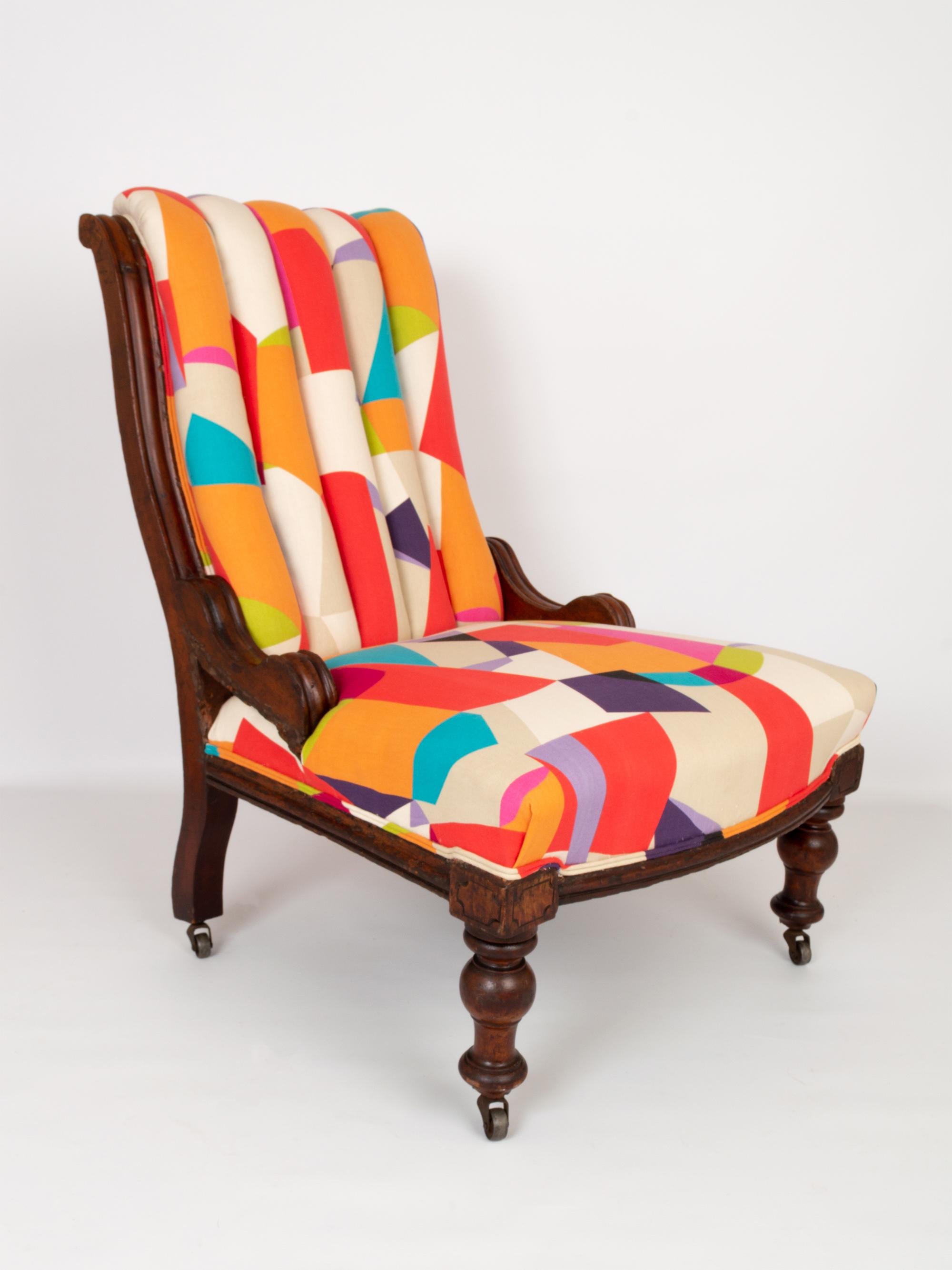 A superb English antique Victorian mahogany framed reading armchair dating from C.1880. Traditionally upholstered and covered in a vibrant and stunningly juxtaposed Sanderson fabric.