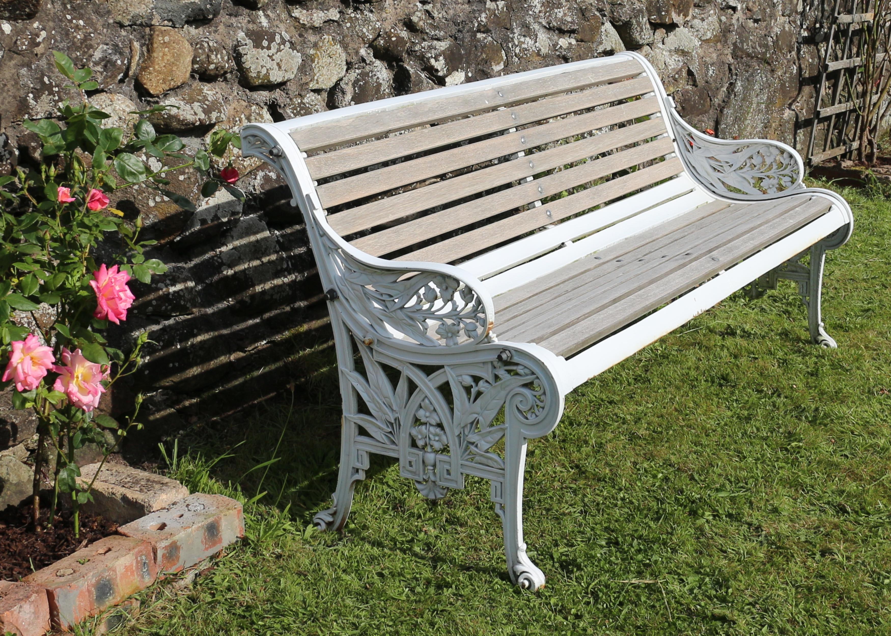 A stylish Victorian Aesthetic cast iron garden seat or bench by the John Finch Foundry and dating to circa 1870. This Arts & Crafts period seat has pierced sides combining formal geometric Greek key decoration with the naturalistic shapes of the