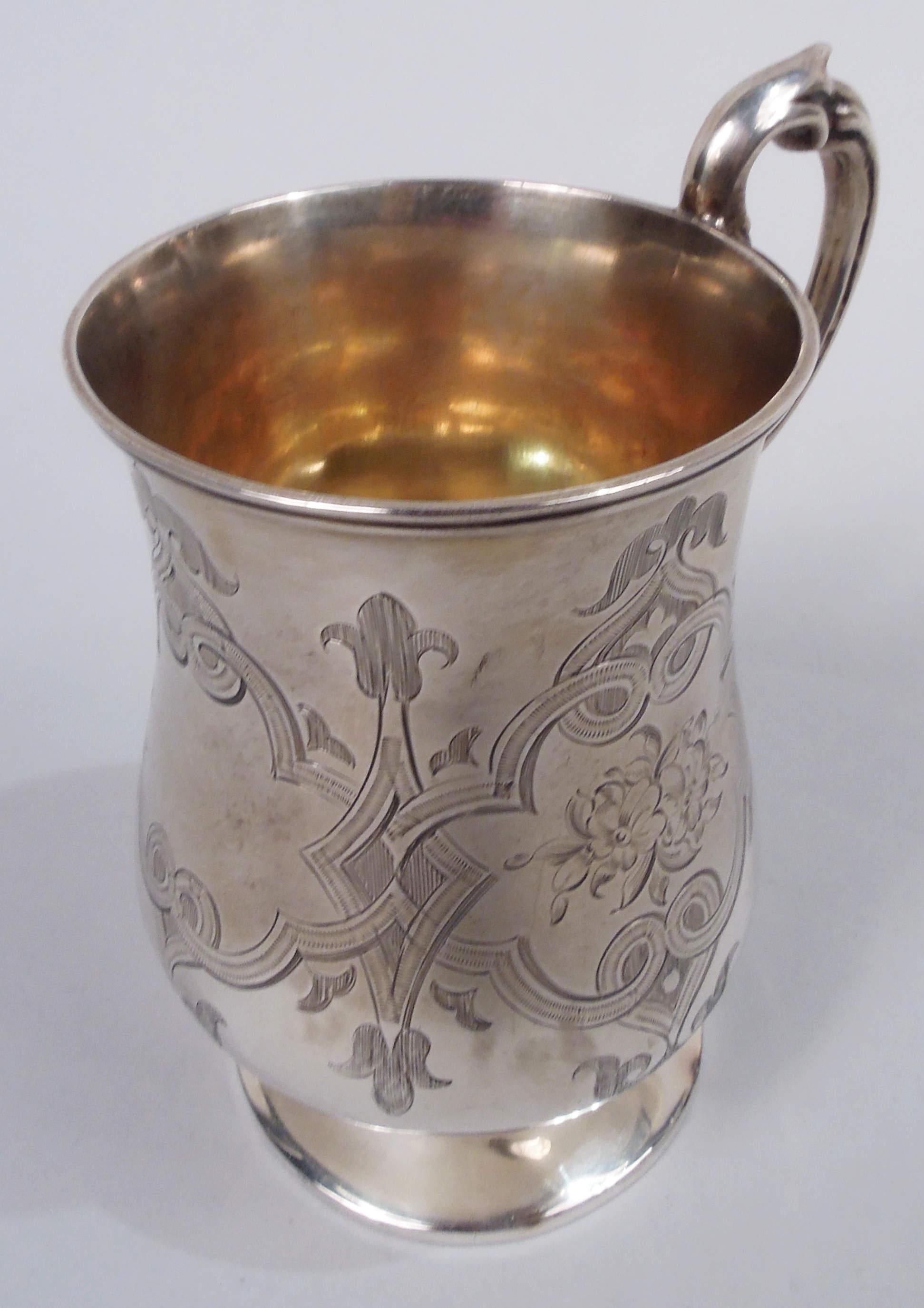 Victorian Classical sterling silver baby cup. Made by John Bell and Frederick Brasted in London in 1860. Baluster bowl on raised foot; leaf-capped double-scroll handle. Engraved interlaced strapwork frames of which two inset with flowers and two