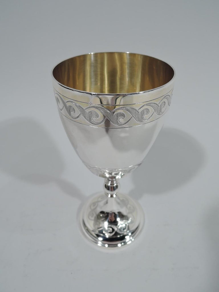 English Victorian sterling silver goblet, 1868. Curved and tapering bowl, knopped and flanged shaft, and raised foot. Engraved ribbon-style guilloche borders. Bowl interior gilt. Fully marked including London assay stamp and worn maker’s mark,