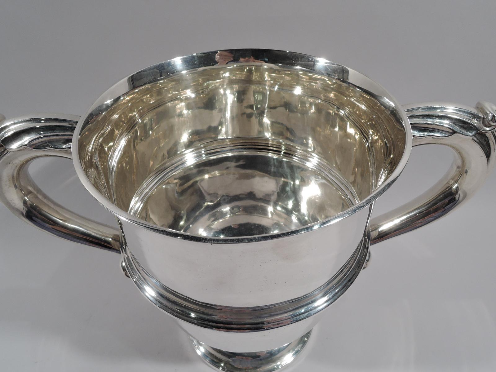 Victorian classical sterling silver urn cup. Made by Elkington in Birmingham in 1896. Girdled with leaf-capped s-scroll side handles and stepped and round foot. Capacious and traditional with lots of room for engraving. Fully marked. Heavy weight: