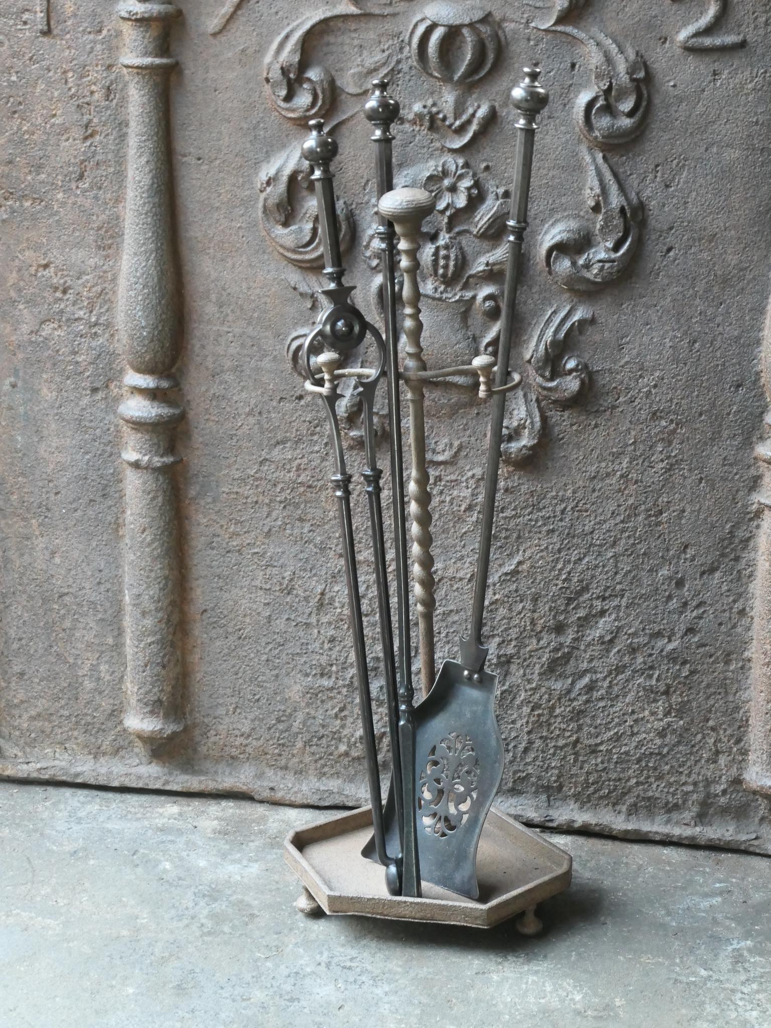 19th century English Victorian period companion set. The tool set consists of thongs, shovel, poker and a stand. Made of cast iron and wrought iron. It is in a good condition and is fully functional.