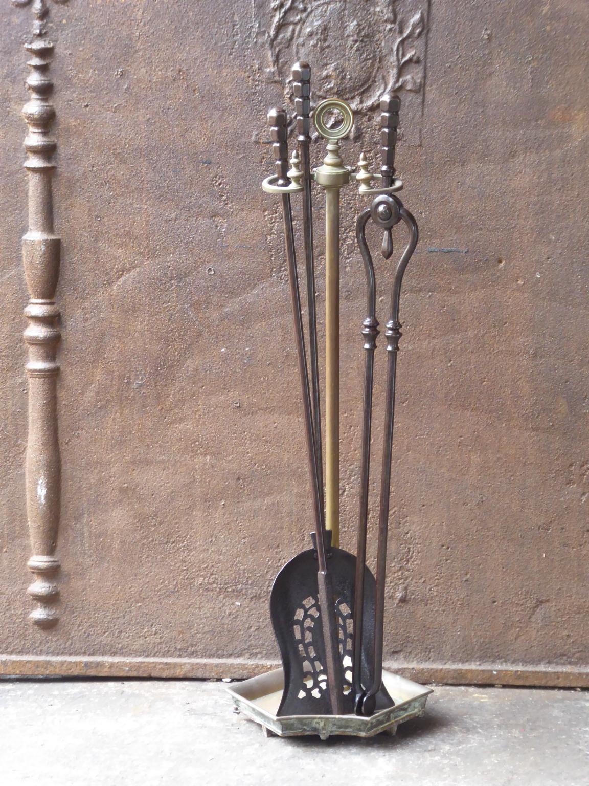 19th century English Victorian fireplace toolset made of brass and wrought iron. The toolset consists of three tools and a Stand. The condition is good.













  