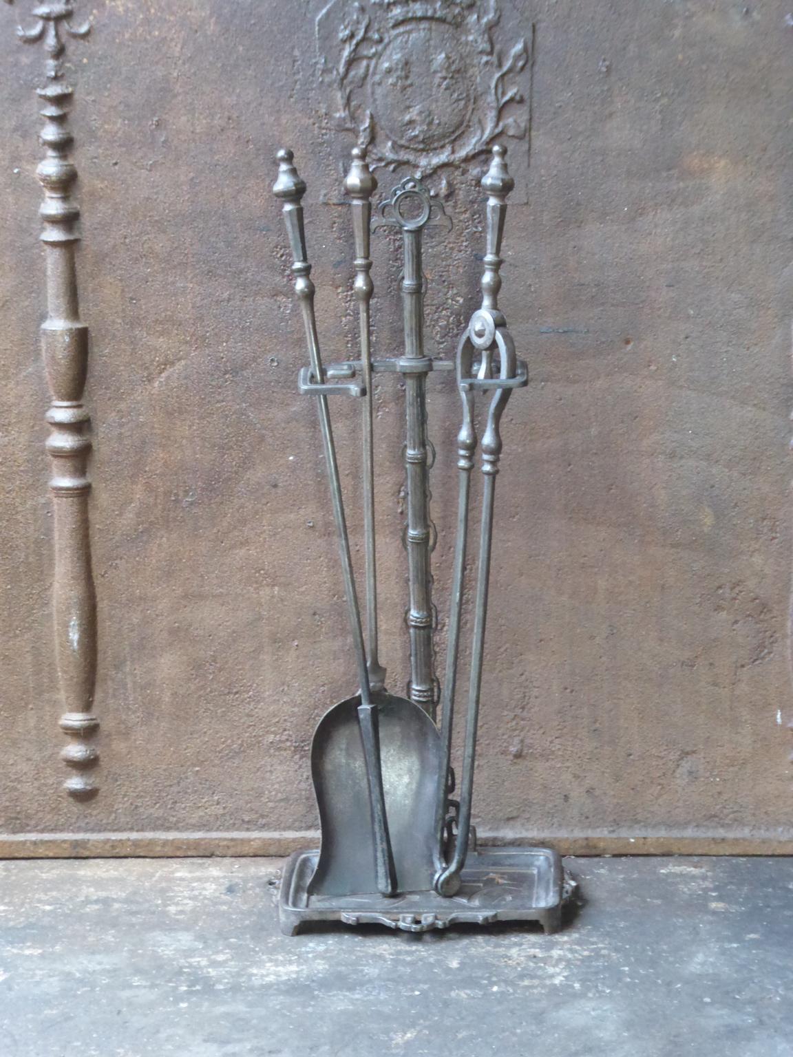 19th century English Victorian fireplace toolset made of cast iron and wrought iron. The toolset consists of three tools and a stand. The condition is good.













  