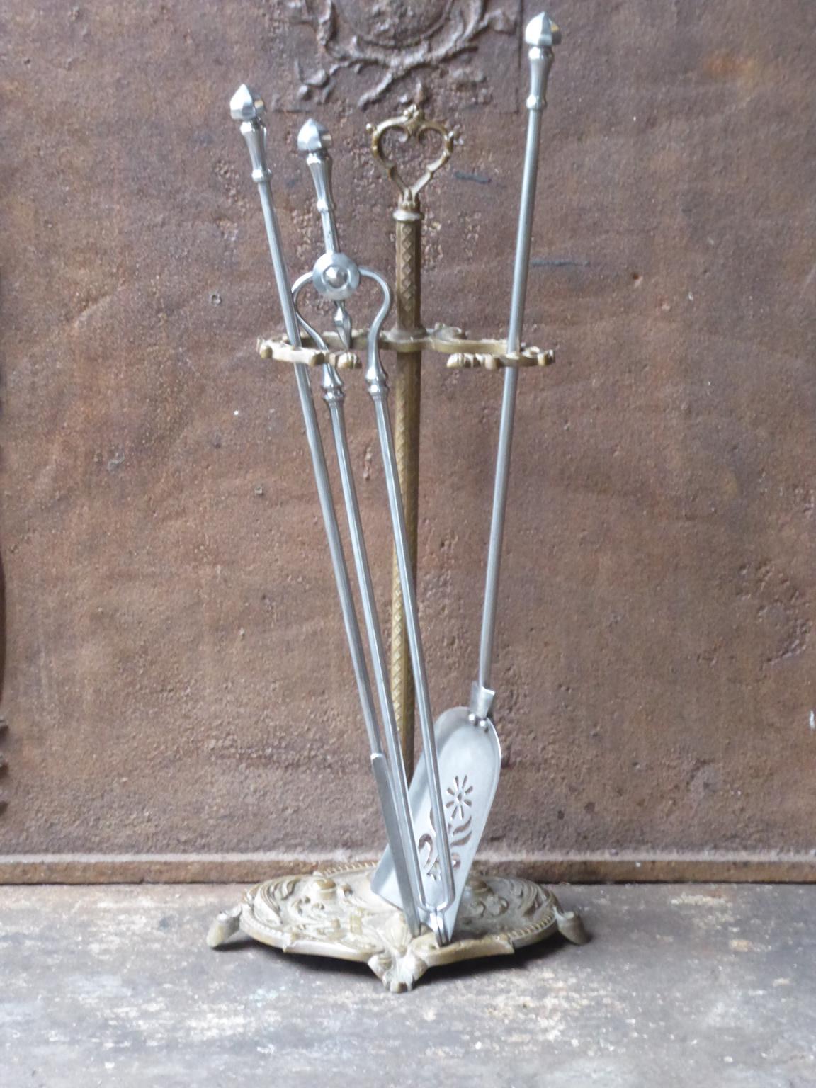 Beautiful 19th century English Victorian fireplace toolset made of brass and polished steel. The toolset consists of three tools and a stand. The condition is good.













 