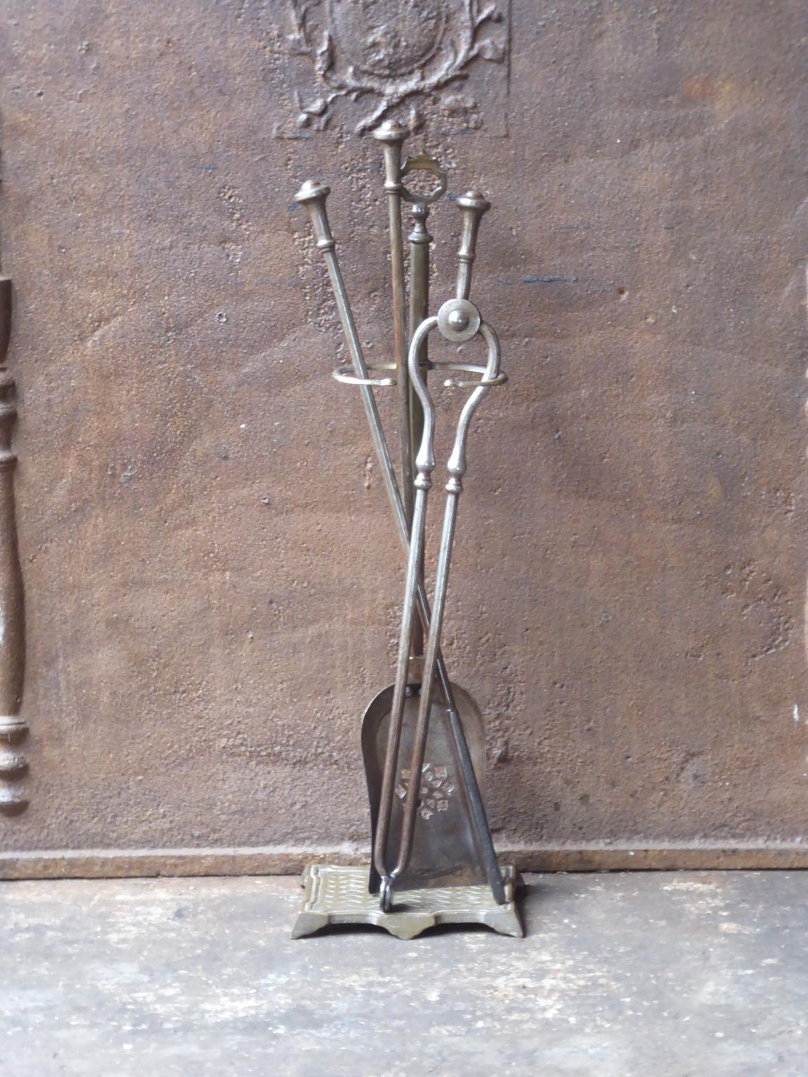 19th century English Victorian fireplace toolset made of wrought iron and brass. The toolset consists of three fire irons and a stand. The condition is good.













 