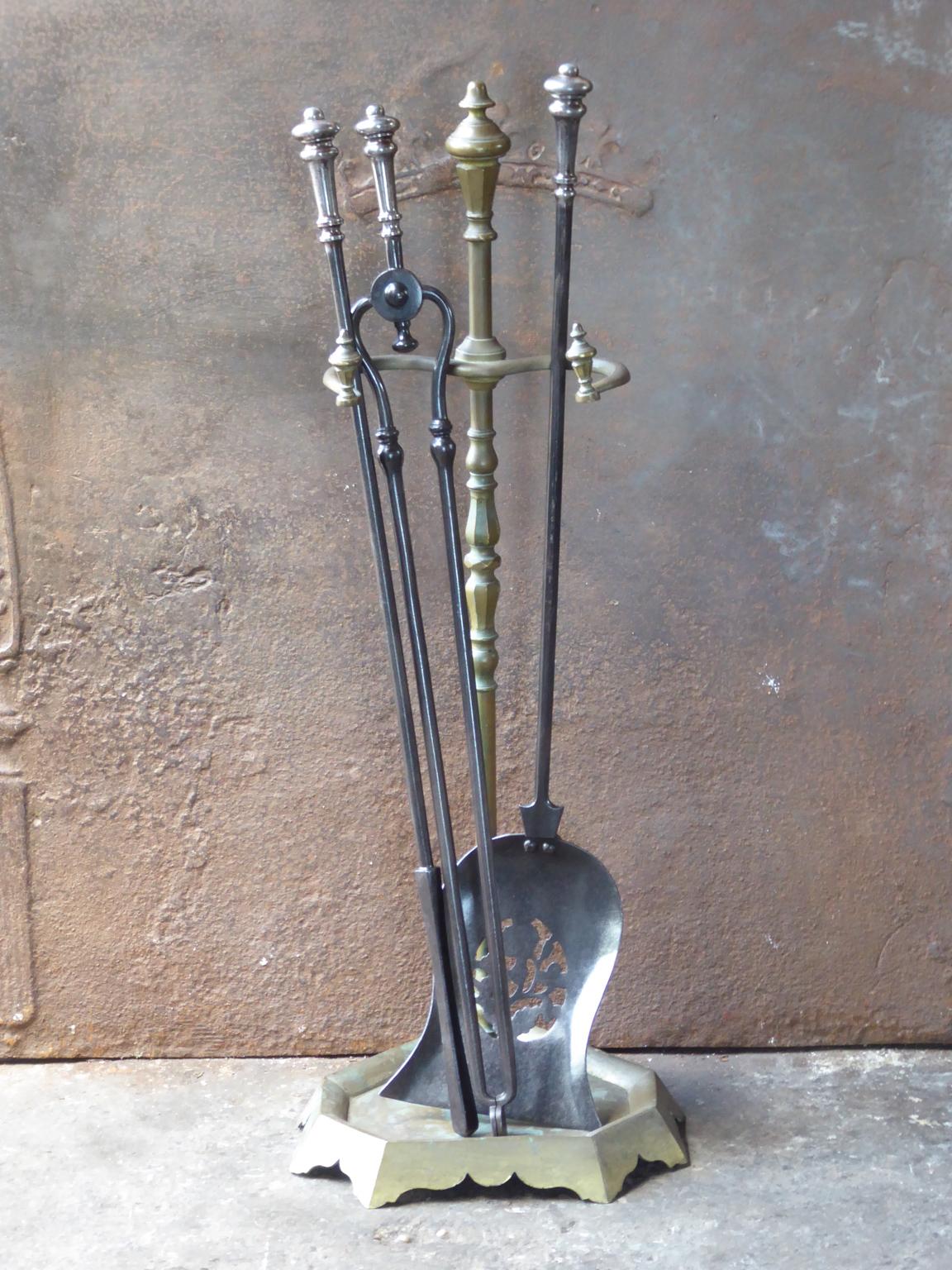 Beautiful 19th century English Victorian fireplace toolset made of brass and polished steel. The toolset consists of three fire irons and a stand. The condition is good.













