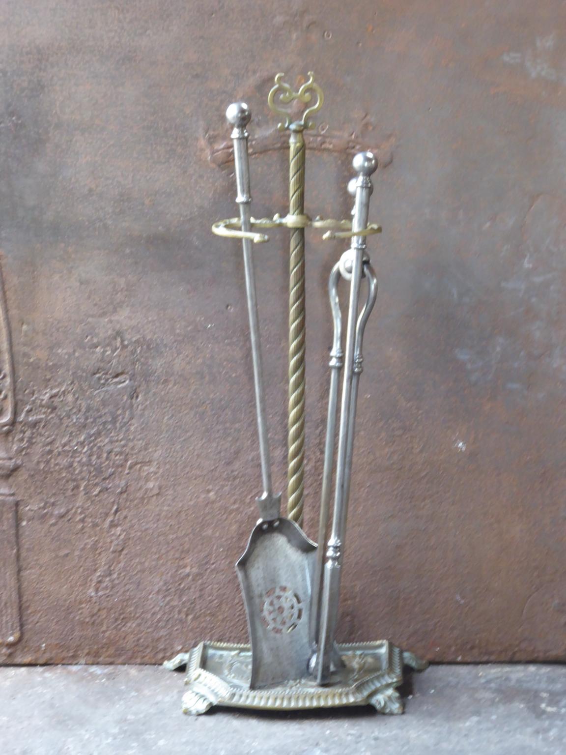 19th century English Victorian fireplace toolset made of polished steel and brass. The toolset consists of three fire irons and a stand. The condition is good.













