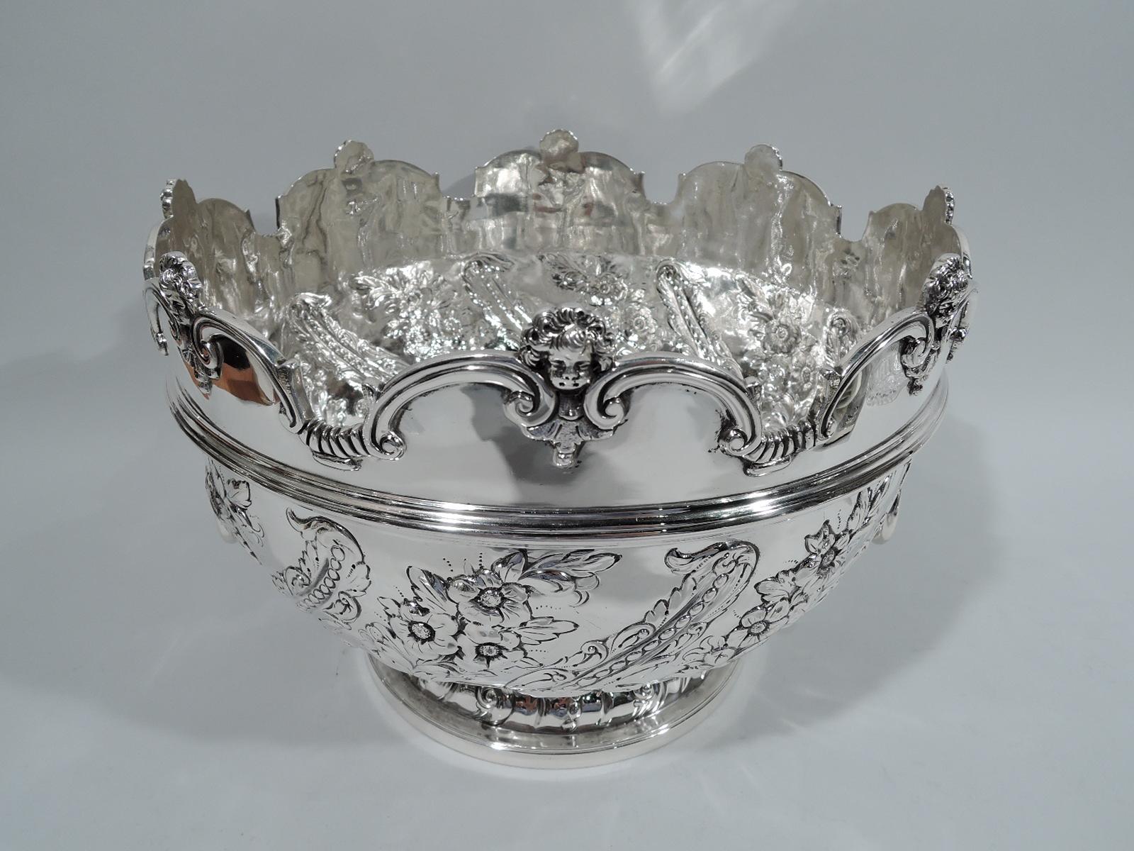 Victorian Georgian sterling silver monteith, 1895. Curved and girdled with cased leaf and flower lobing, and lion’s head side mounts with beaded and loose-mounted open bracket handles. Rim has applied and molded double C-scrolls with leaves and