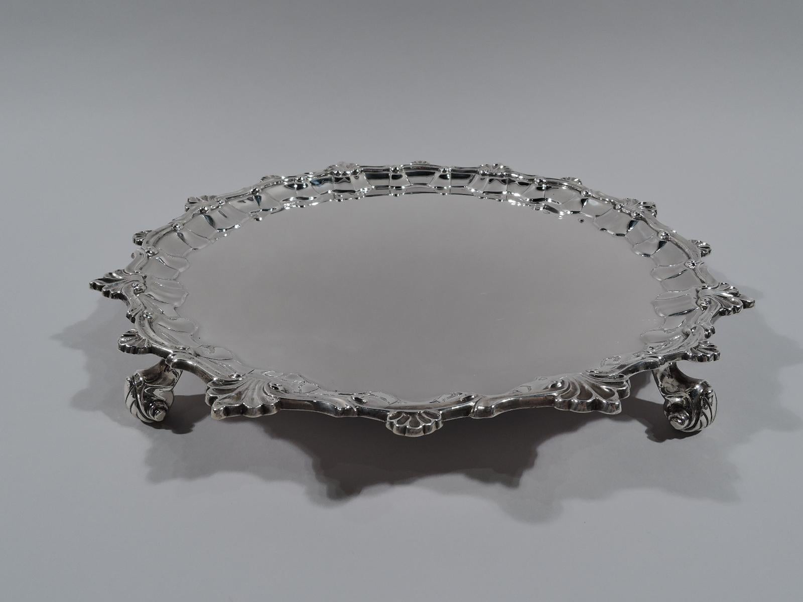 Victorian Georgian sterling silver salver. Made by Elkington & Co. in Birmingham in 1894. Molded and scrolled rim with applied scallop shells alternating with leaves. Four leaf-capped volute scroll supports. Fully marked. Weight: 32 troy ounces.