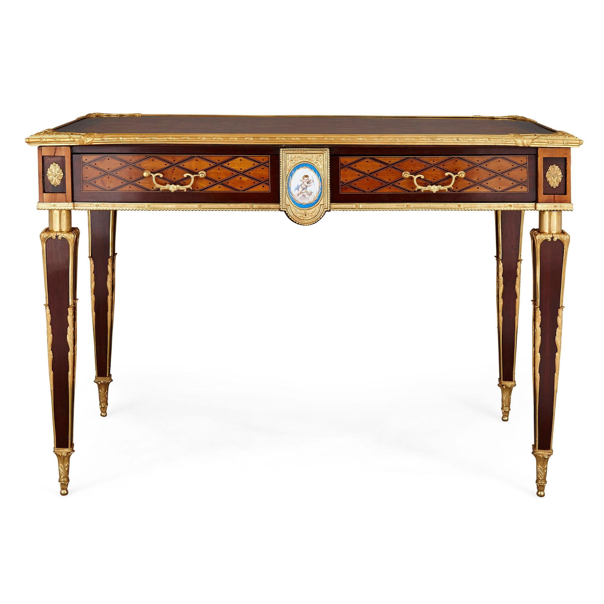 Antique English Victorian marquetry writing desk by Donald Ross
English, c. 1890
Measures: Height 75cm, width 108cm, depth 64cm

This superb mahogany writing desk by Donald Ross features Ross’ distinctive “trellis and dot” marquetry of satinwood