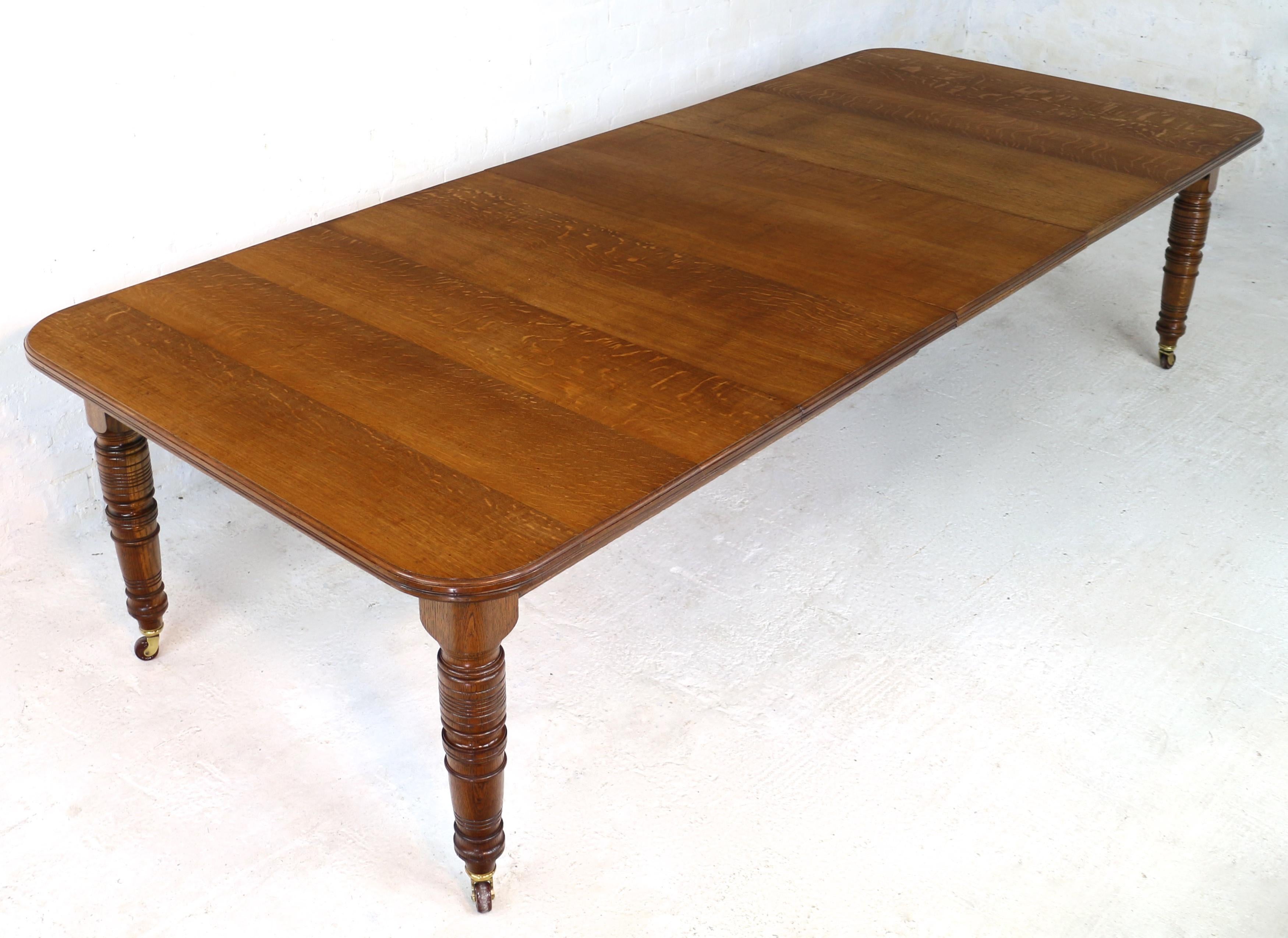 An attractive mid Victorian wind-out extending dining table in quarter-sawn oak and dating to circa 1870. With a rectangular top with rounded corners and a moulded edge it stands on four Arts & Crafts style ring-turned tapering legs with brass caps