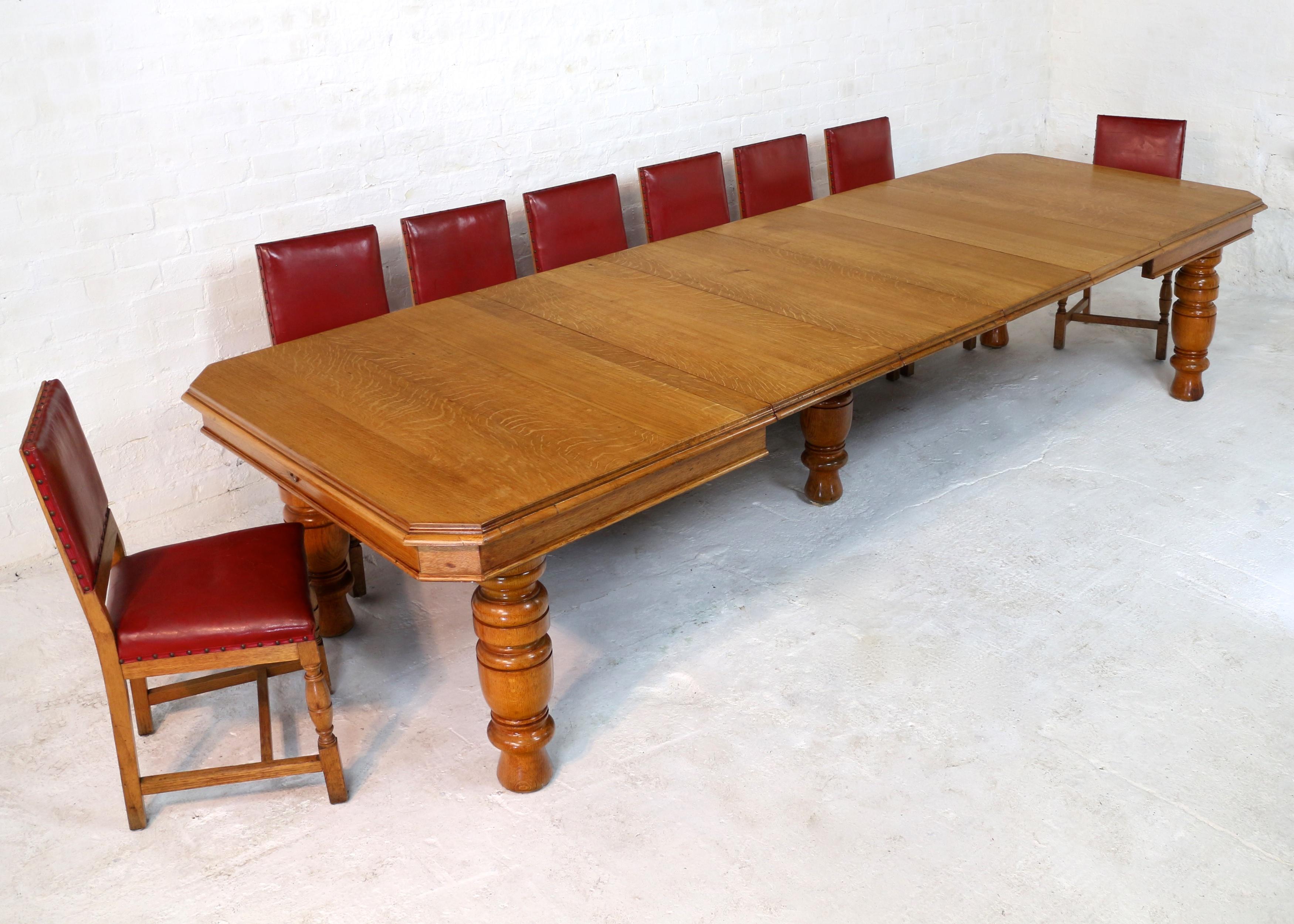 A large Victorian wind-out extending dining table in golden quarter-sawn oak with four additional leaves and winding handle. The rectangular top with canted or cut corners and a double moulded edge, it stands on five substantial turned legs. This 47