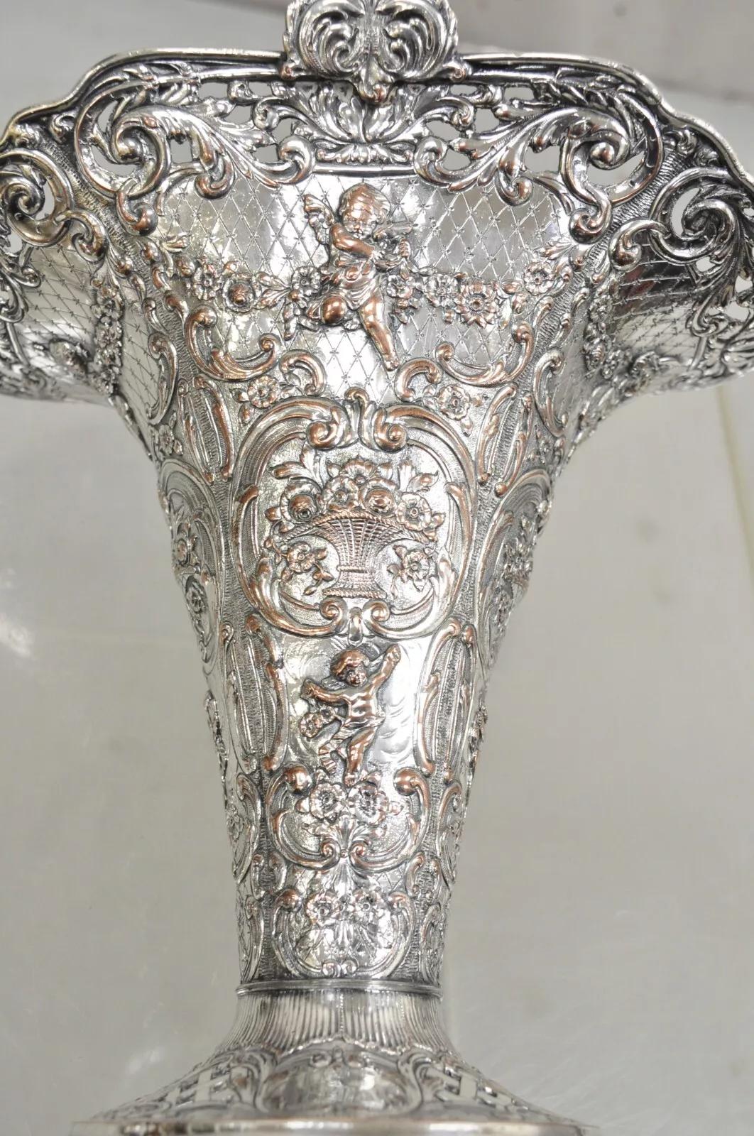 Antique English Victorian Repousse Silver Plated Cherub Vase Brides Basket. Item features ornate cherub scrollwork and floral bouquet repousse, 