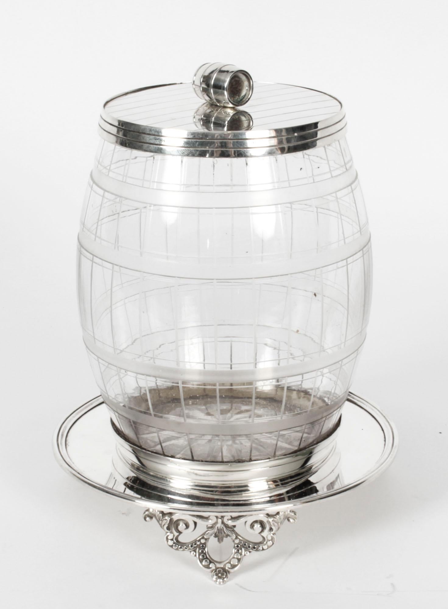 Antique Victorian silver plated & cut glass biscuit barrel, circa 1890 in date.
This exquisite barrel shaped box has a lid with a further barrel handle, and the glass body features engraved criss cross linear lines.

It stands on a circular base