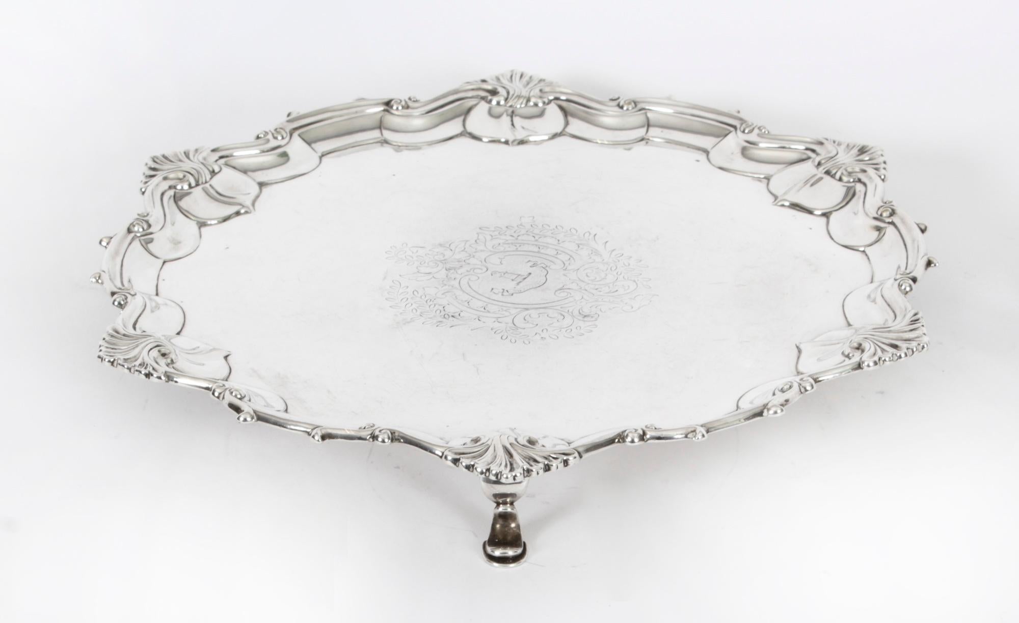 This is a wonderful antique silver plated Victorian salver bearing the makers mark of William Hutton & Sons, and dating from Circa 1860.
 
It has beautiful engraved floral and foliate decoration in the Neo-classical style and is raised on elegant