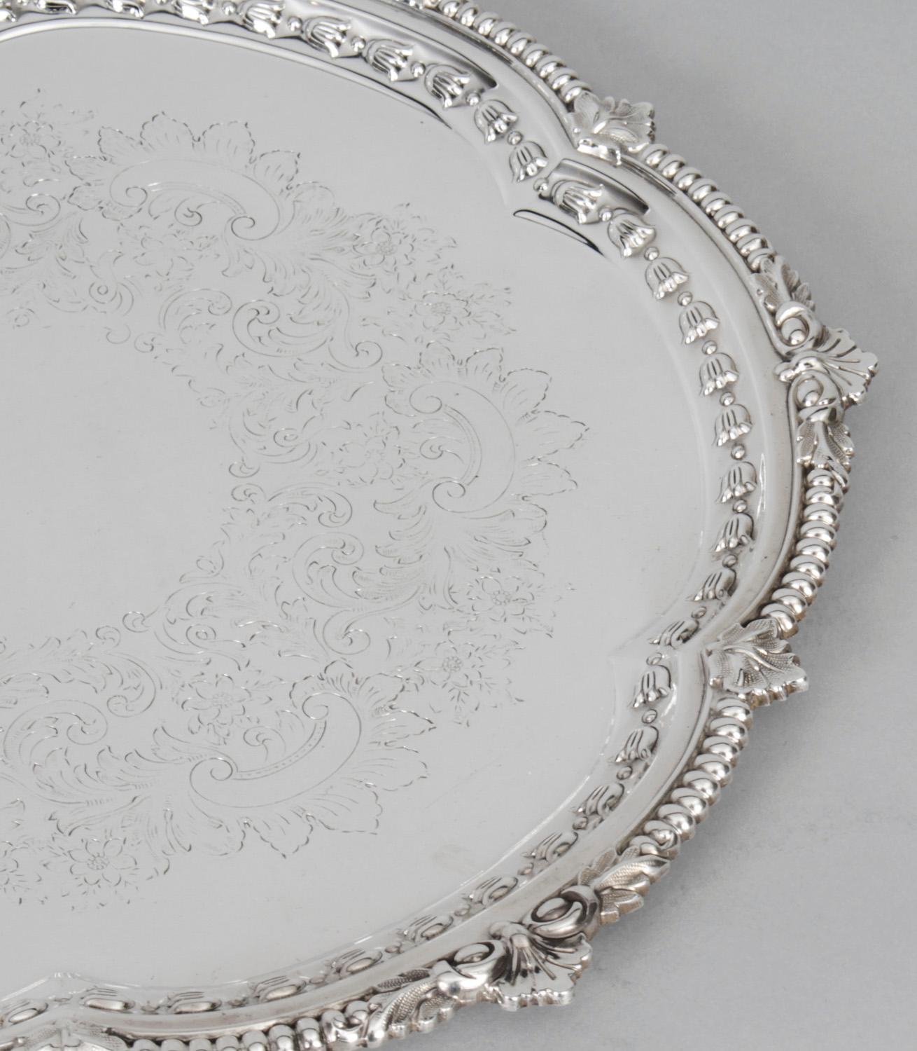 This is a wonderful antique silver plated Victorian salver bearing the makers mark of the renowned silversmith Barker Ellis and late 19th Century in date.
 
It has beautiful embossed and engraved floral and foliate decoration in the neo-classical