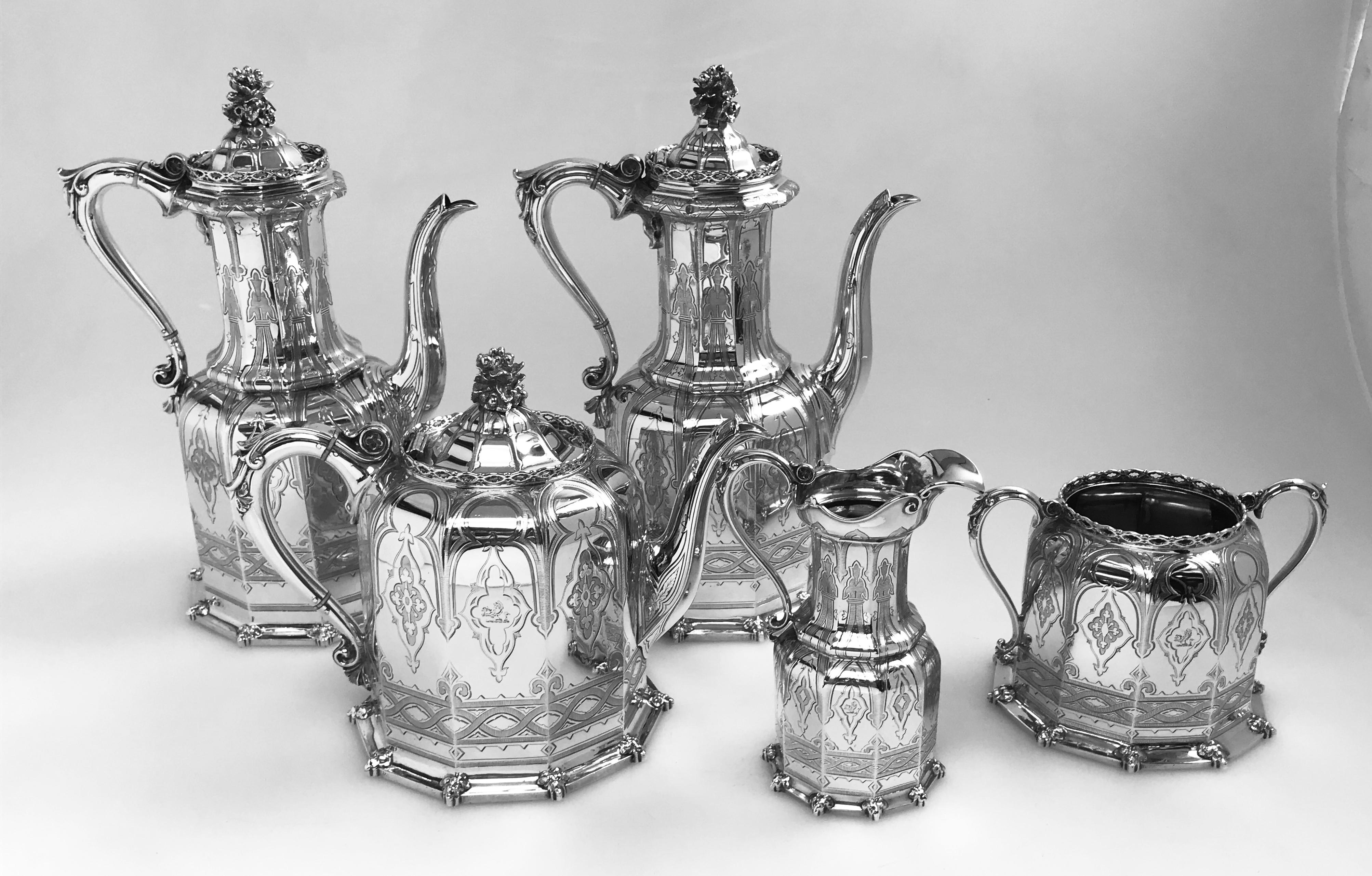 A 5-piece silver tea and coffee set hallmarked in the year 1853 in Birmingham, England by the internationally renowned firm of Elkington & Co. The set is in the neo-Gothic style that was popular in the mid-1850s, and consists of two coffee pots, one