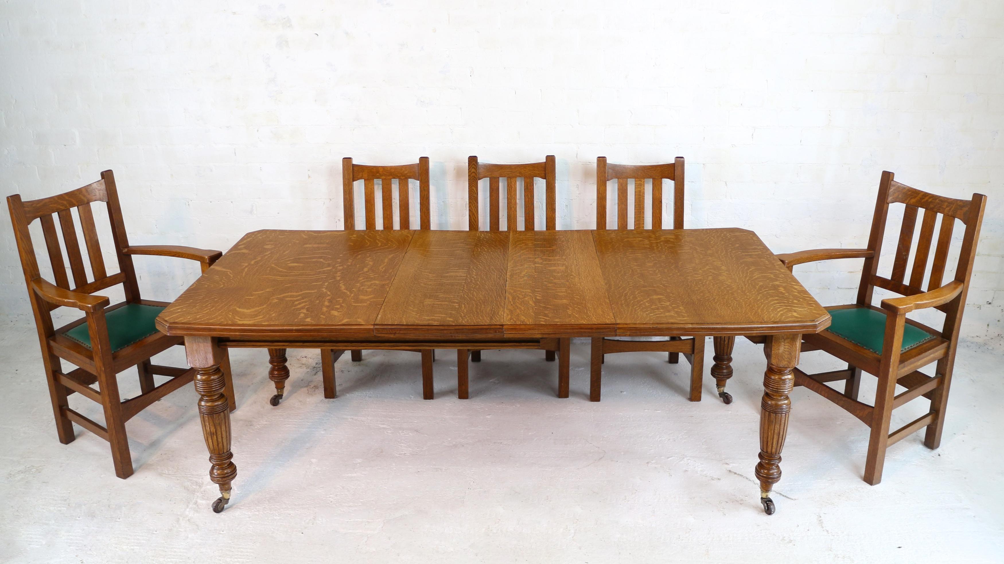 An attractive late Victorian small wind-out extending dining table in quarter-sawn oak with two original leaves and dating to circa 1880. With an Arts & Crafts influence it has a rectangular top with canted corners and a moulded edge and stands on