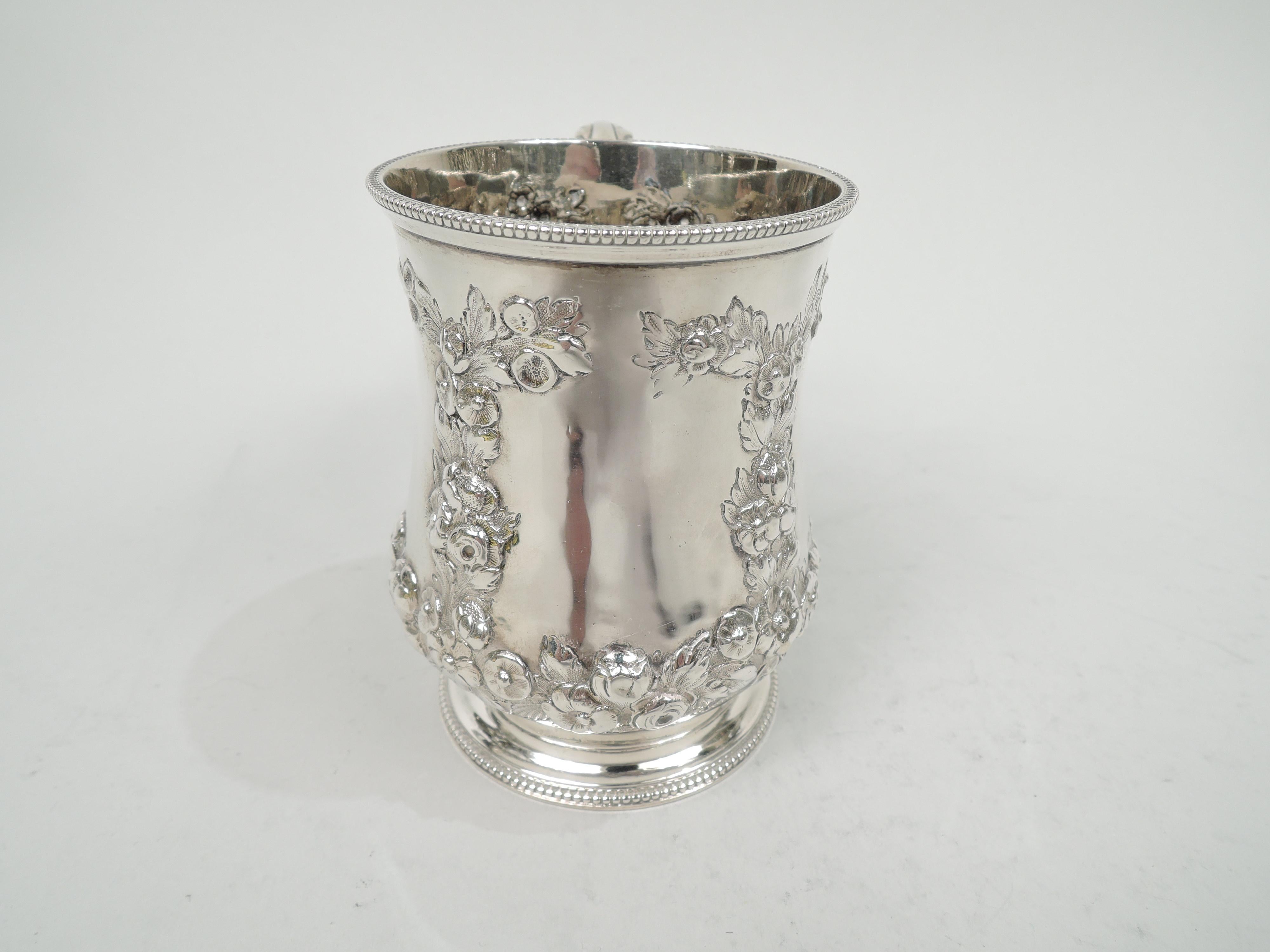 Victorian sterling silver baby cup. Made by Daniel & Charles Houle in London in 1870. Baluster bowl with leaf-capped double-scroll handle and raised foot. Garlands forming four rectilinear frames (vacant). Beaded rims. Weight: 6 troy ounces.