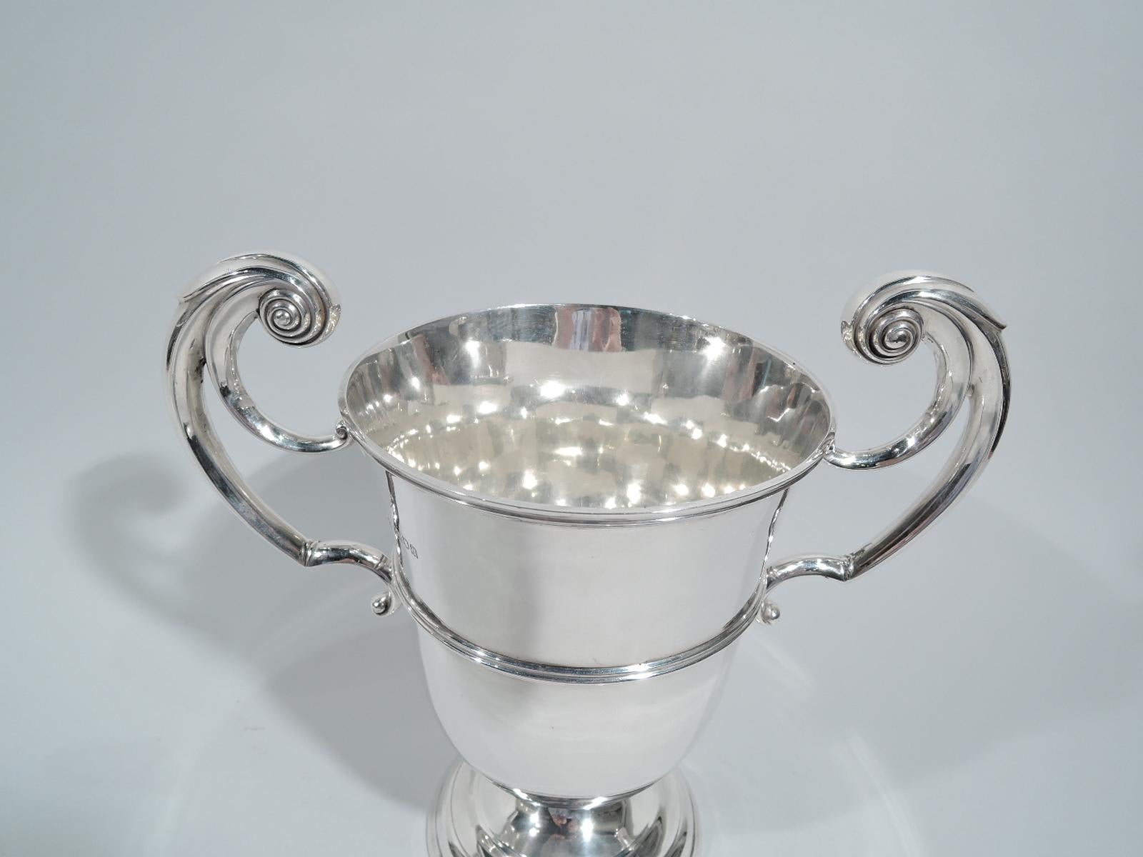 Victorian sterling silver urn. Made by Sibray, Hall & Co. in London in 1899. Tapering and girdled with flying scroll side handles and domed foot. Traditional form with lots of room for engraving. Fully marked. 

Overall dimensions: H 10 1/8 x W 11