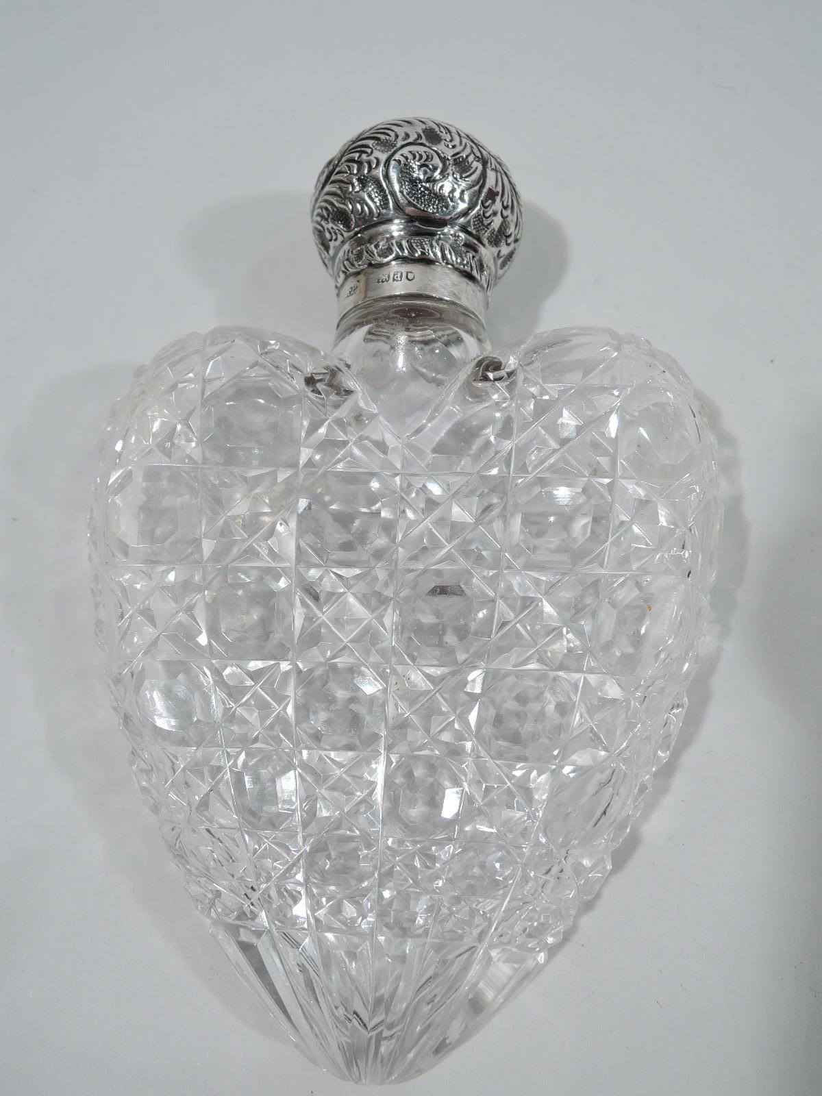 Victorian cut-glass flask with sterling silver cover. Made by Robert Pringle & Sons in London in 1899. Heart-form with flat sides and diaper pattern. Ball cover threaded and cork-lined with tooled leafing scrolls and vacant top. A lady's medicinal