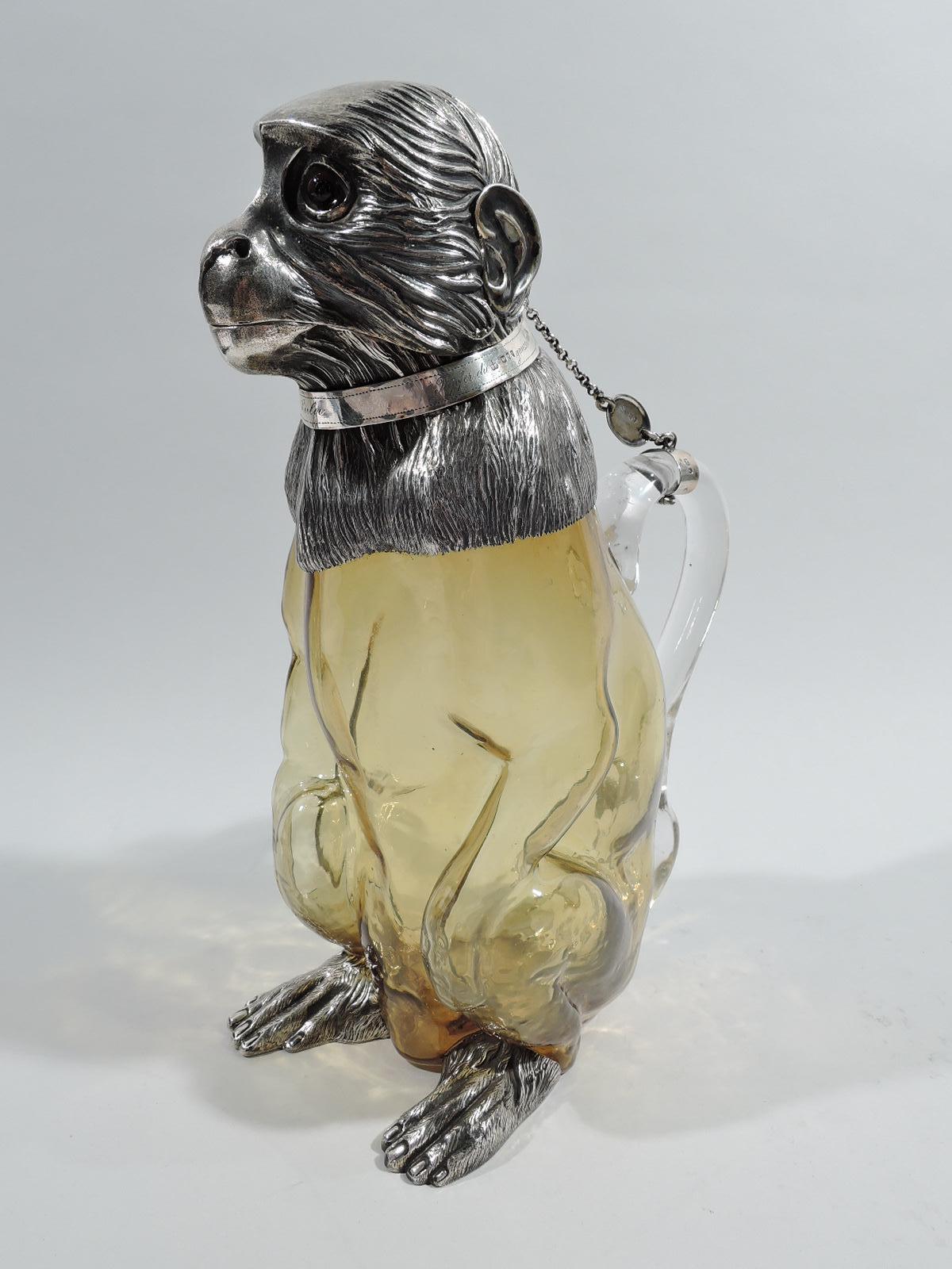 Victorian sterling silver and glass figural monkey decanter. Made by Richard Hodd & Son in London in 1893. Glass body with hands resting on haunches. Tail-form handle. Tensile hind paws in sterling silver as is shaggy-furred shoulder mount with