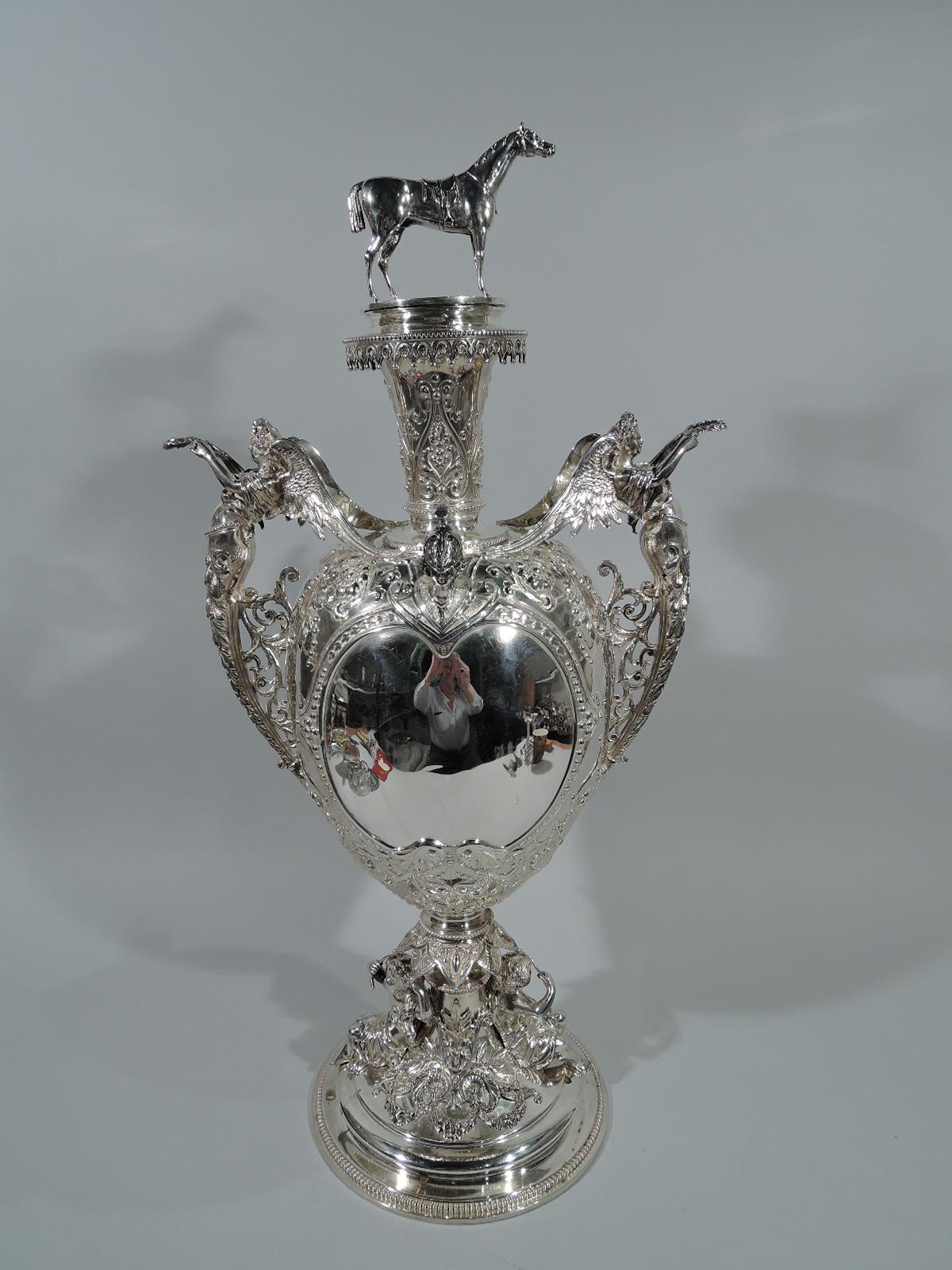 Victorian sterling silver trophy. Made by Edgar Finley and Hugh Taylor in Birmingham in 1883. Ovoid on stepped domed foot. Tapering inset neck on beaded spool base with flat cover. Cast figures, including horse finial, wing-mounted caryatid side