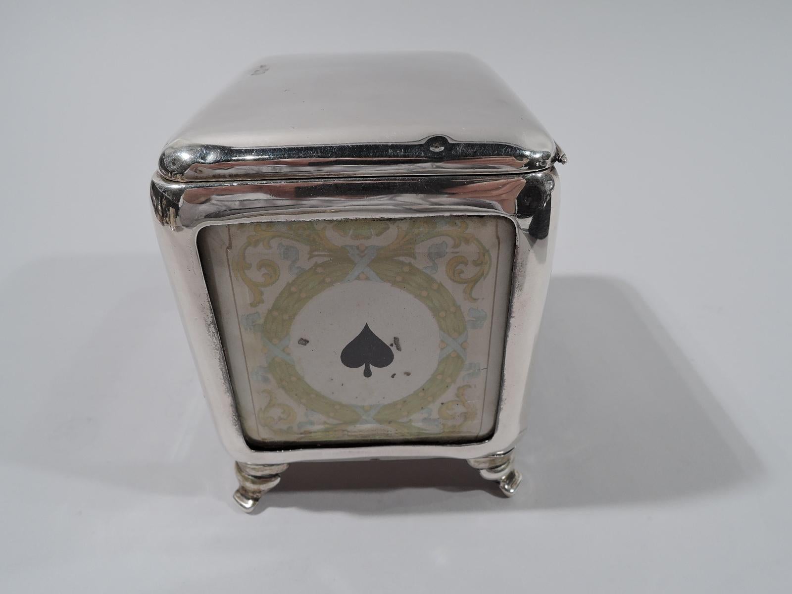 Victorian sterling silver playing cards box. Made by Grey & Co. in London in 1899. Horizontal and rectangular with hinged and tabbed cover, and splayed corner supports. Open sides faced with antique playing card, and glazed with beveled glass.