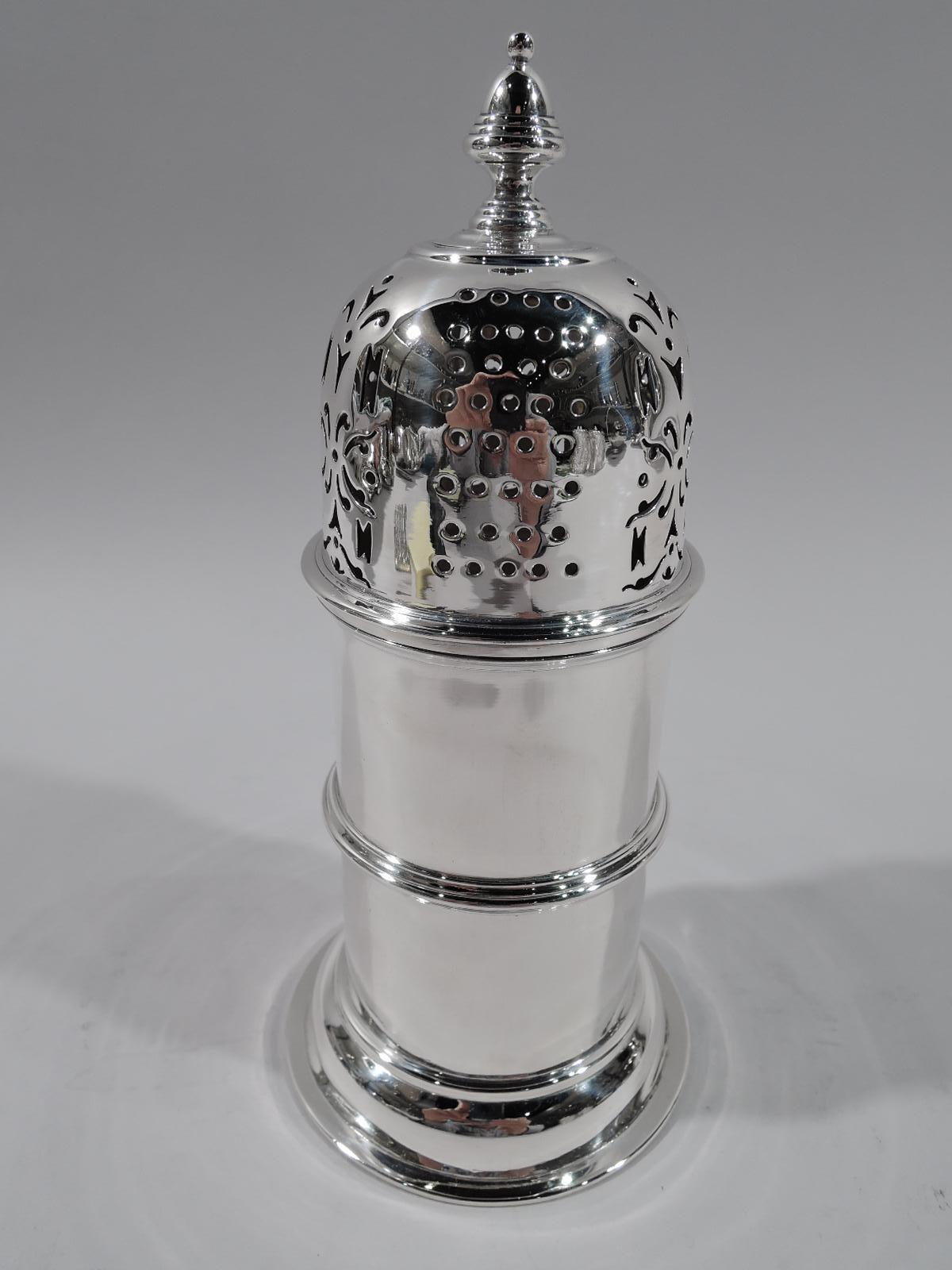 Victorian sterling silver sugar caster. Made by John Hennell in London in 1895. Girdled cylinder on domed foot. Domed cover with vase finial and ornamental piercing. Fully marked. Weight: 8 troy ounces.