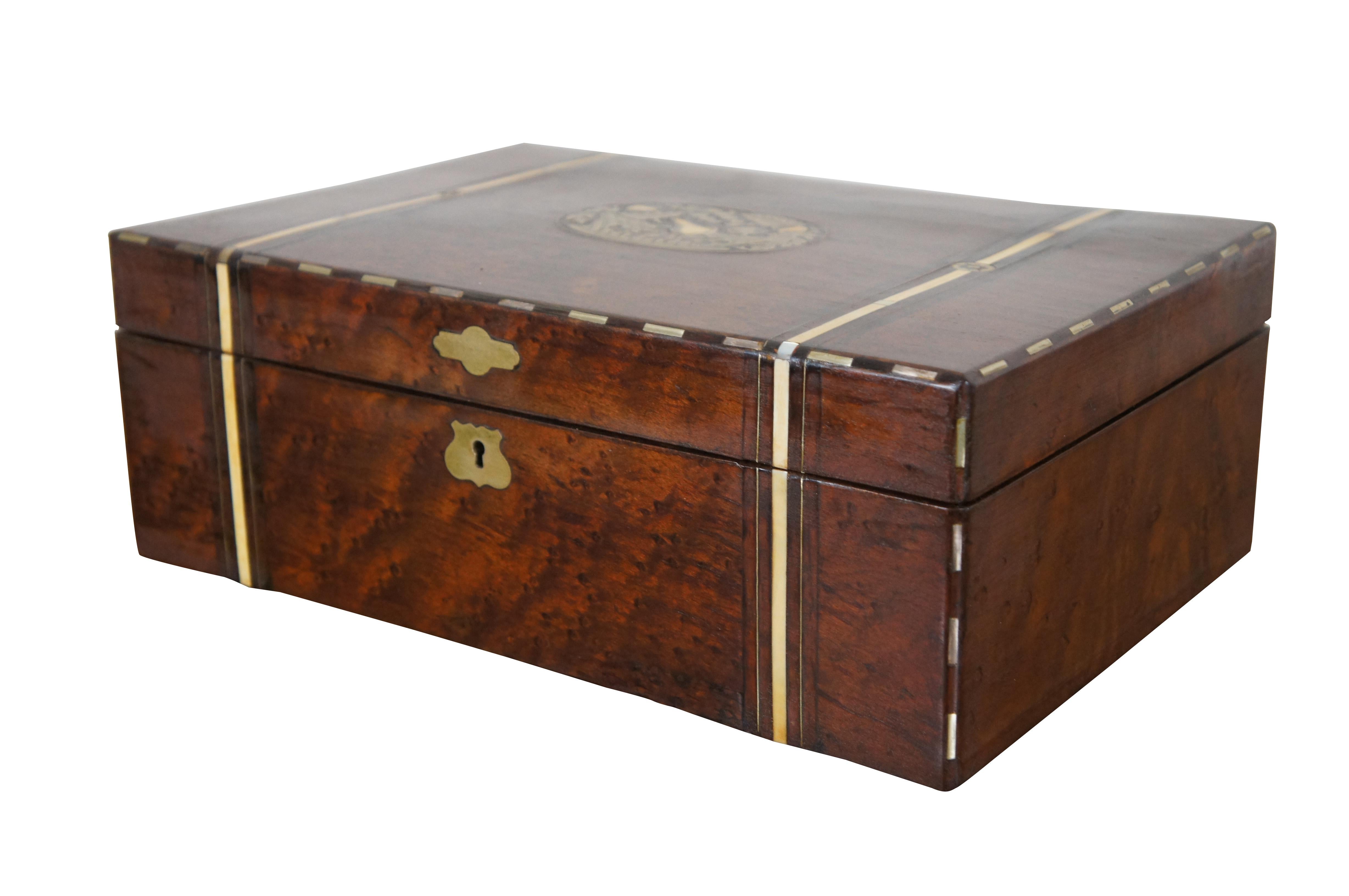 A superb antique 19th century English Victorian burled walnut travel campaign vanity box featuring inlaid brass fruit basket motif with mother of pearl banded accents.  The chest opens to a Rosewood framed mirror that lifts for letter storage, and a