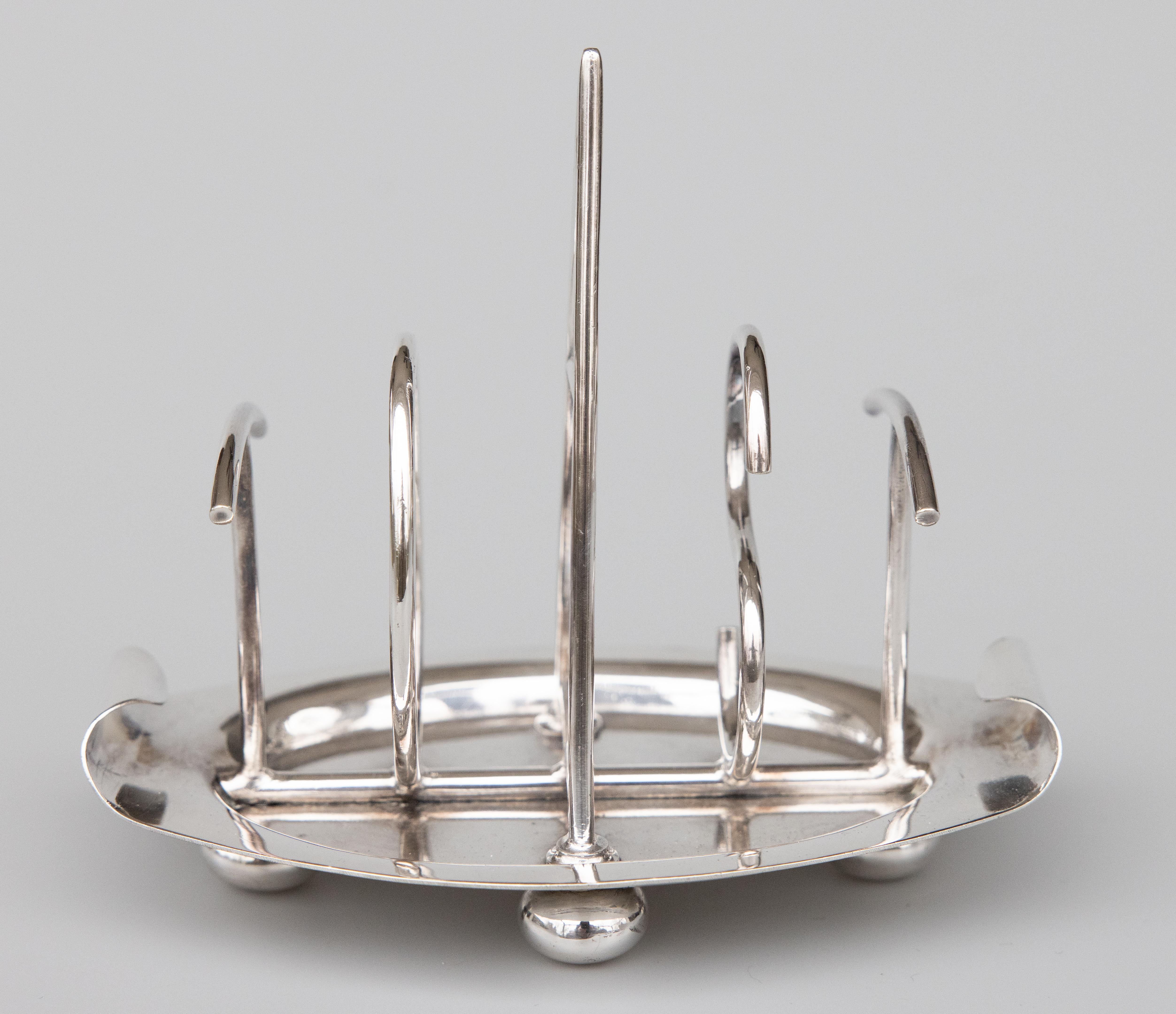 A superb antique English silverplated four slice toast rack made by Walker & Hall of Sheffield, England, dated 1903. Maker's mark on reverse. This Fine quality silver toast rack is well made with a lovely Art Deco design shaped in the word 