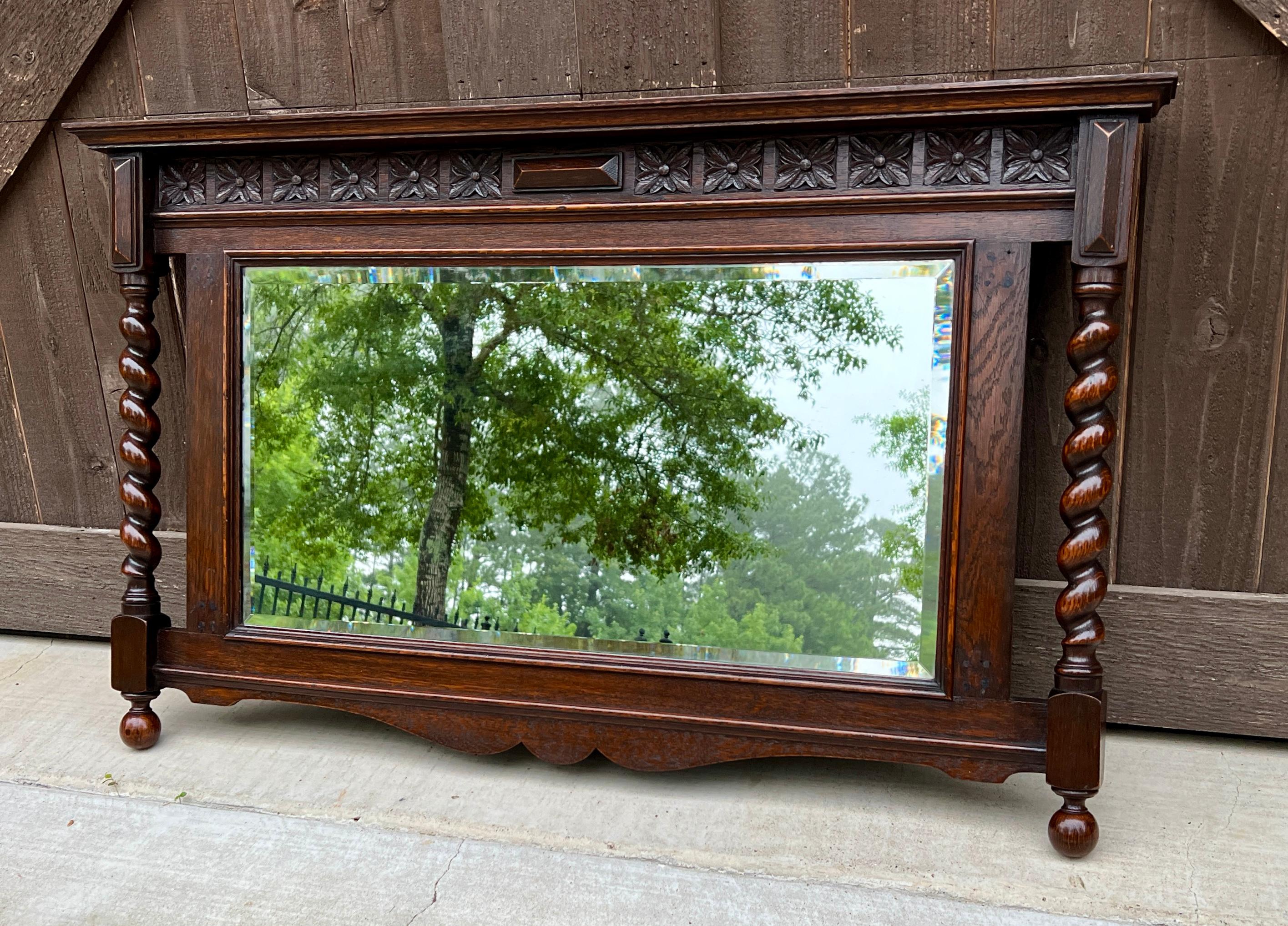 CHARMING Antique English Jacobean Style Rectangular Framed Oak Mirror w/Barley Twist Posts and Beveled Mirror~~c. 1930s
 
Popular classic English hanging wall mirror~~beautifully carved with wood back~~perfect for a fireplace mantel, entry hall,