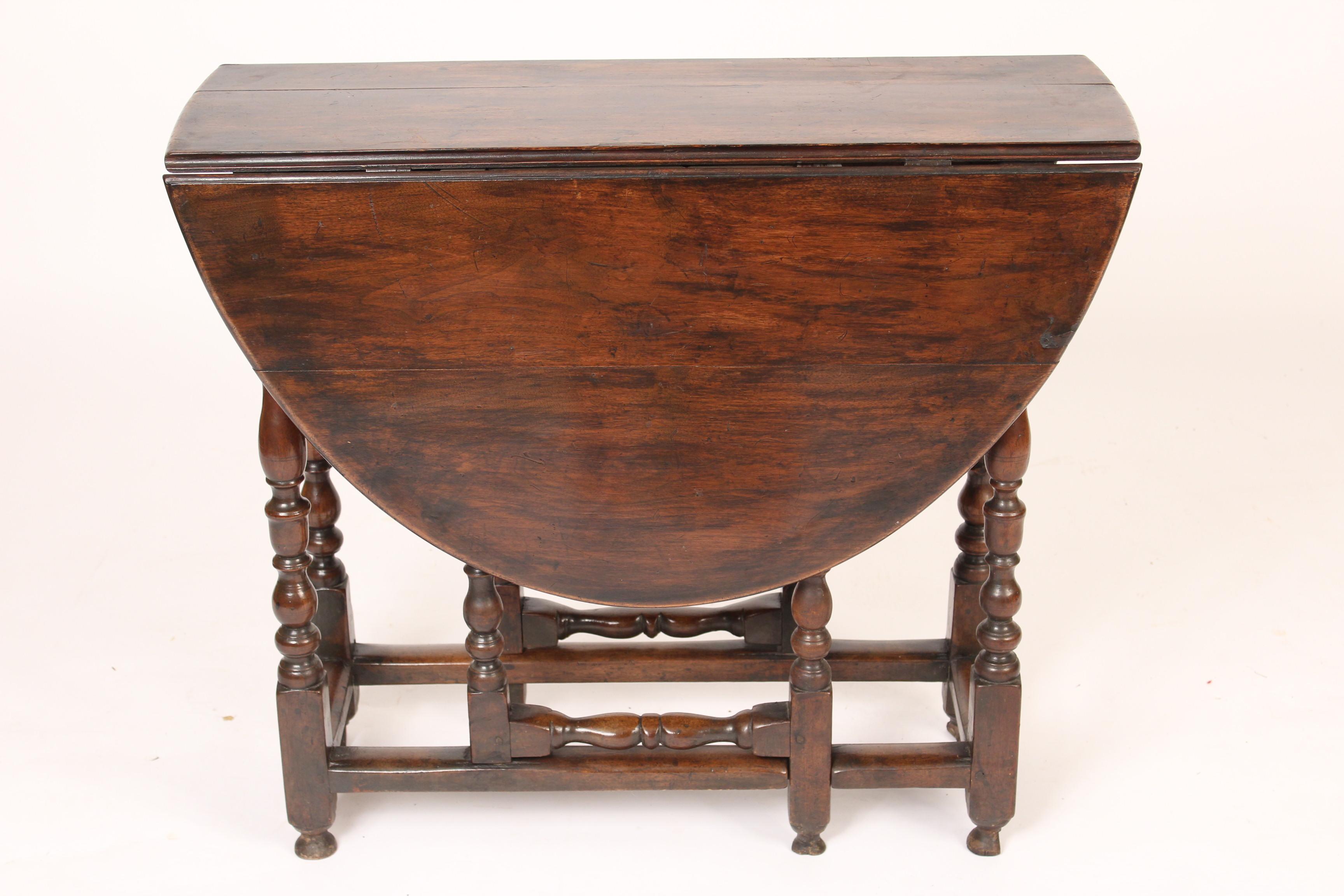 Antique English walnut gate leg table, late 19th century. Each drop leaf is 16.5