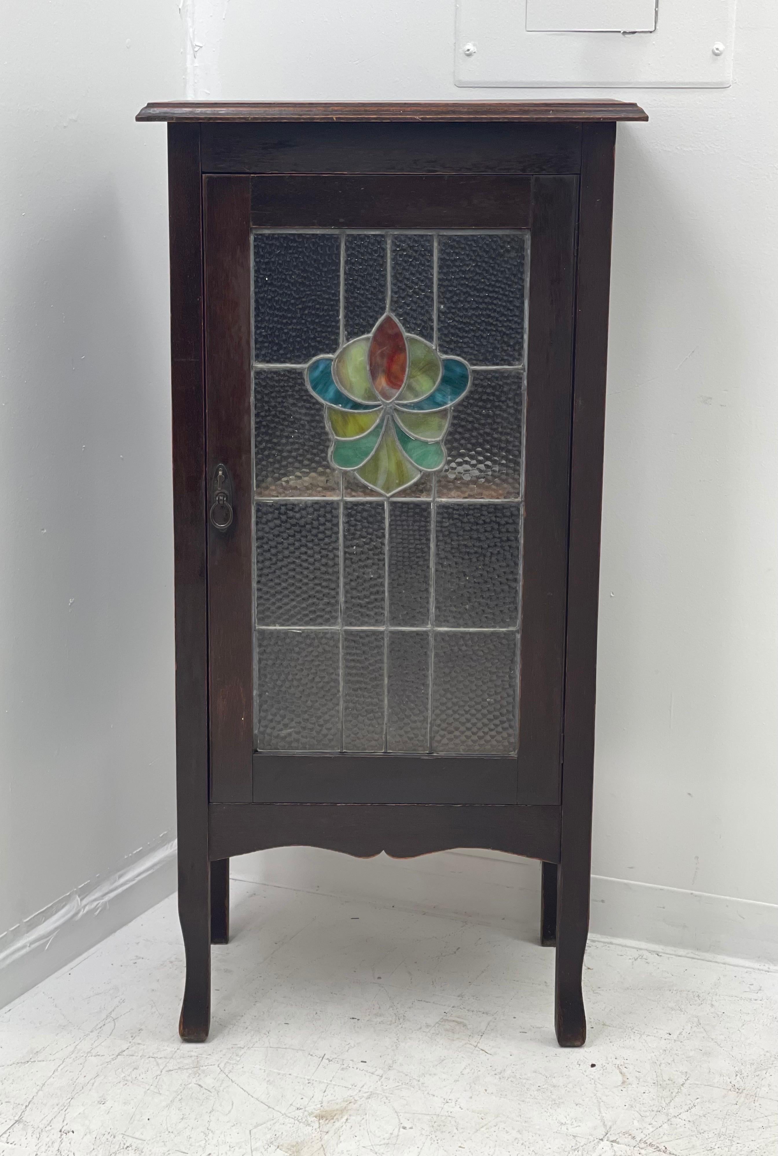 Antique English walnut storage cabinet or entryway bookcase shelf stand with original stained glass.