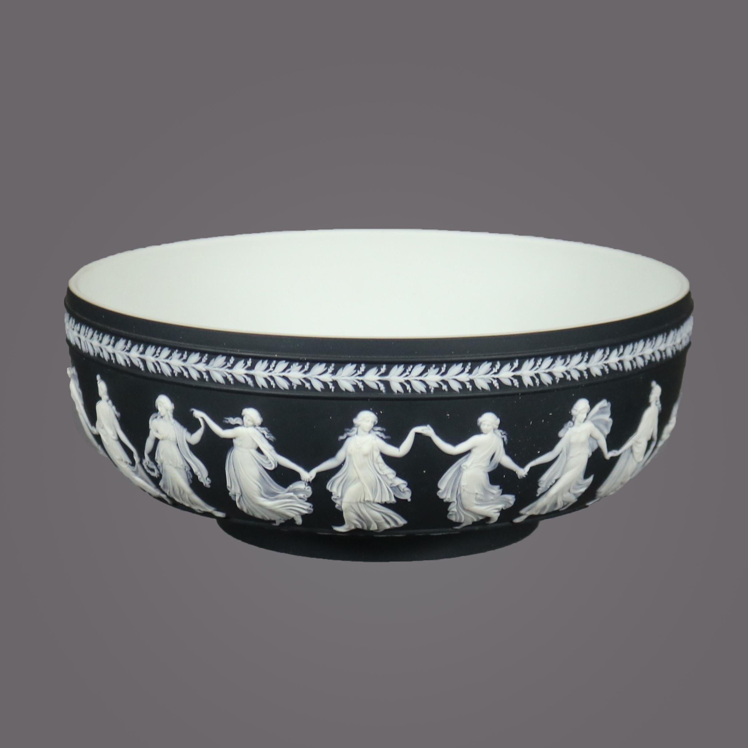An antique English bowl by Wedgwood offers black basalt porcelain with Classical figures dancing, maker mark on base as photographed, circa 1900

Measures - 4