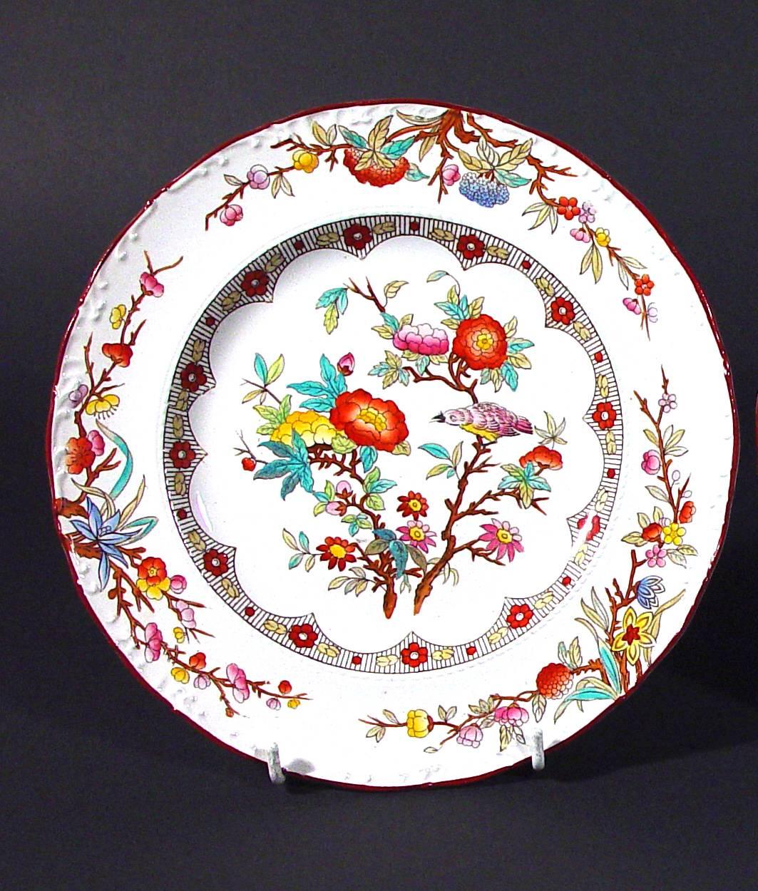 Wedgwood pottery pearlware set of six plates,
circa 1870.

The Wedgwood plates are brightly printed with a central scene of two flowering branches with a bird sitting on one. The rim has three similarly bright flowering branches.

