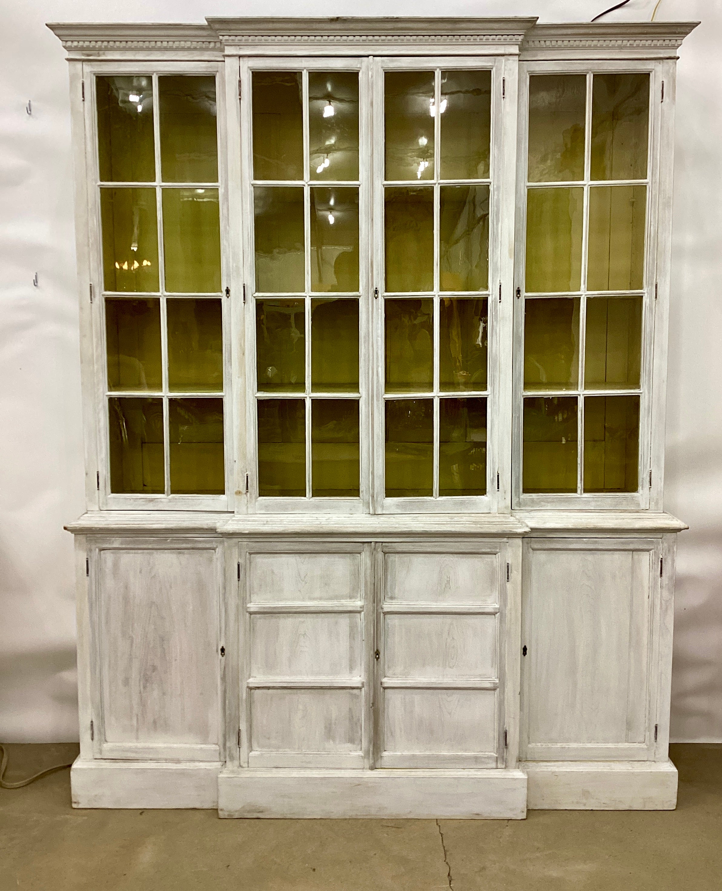 Fabulously proportioned and well sized two-part painted Pine English bookcase/cabinet from the late circa 19th century featuring a glazed upper section with two doors flanking a center double door and lined with adjustable shelves with a fun yellow