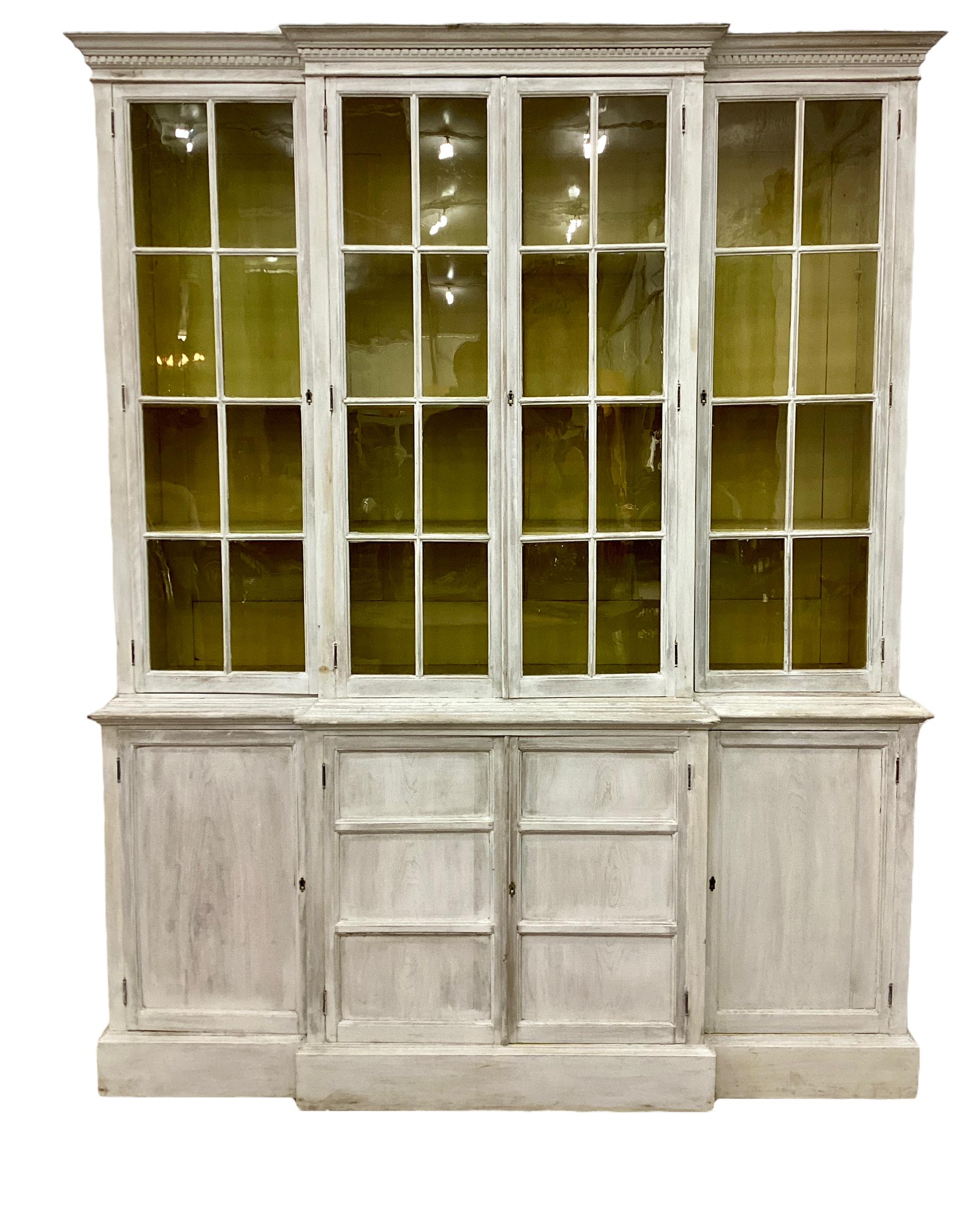 Fabulously proportioned and well sized two-part painted Pine English bookcase/cabinet from the late circa 19th century featuring a glazed upper section with two doors flanking a center double door and lined with adjustable shelves with a fun yellow