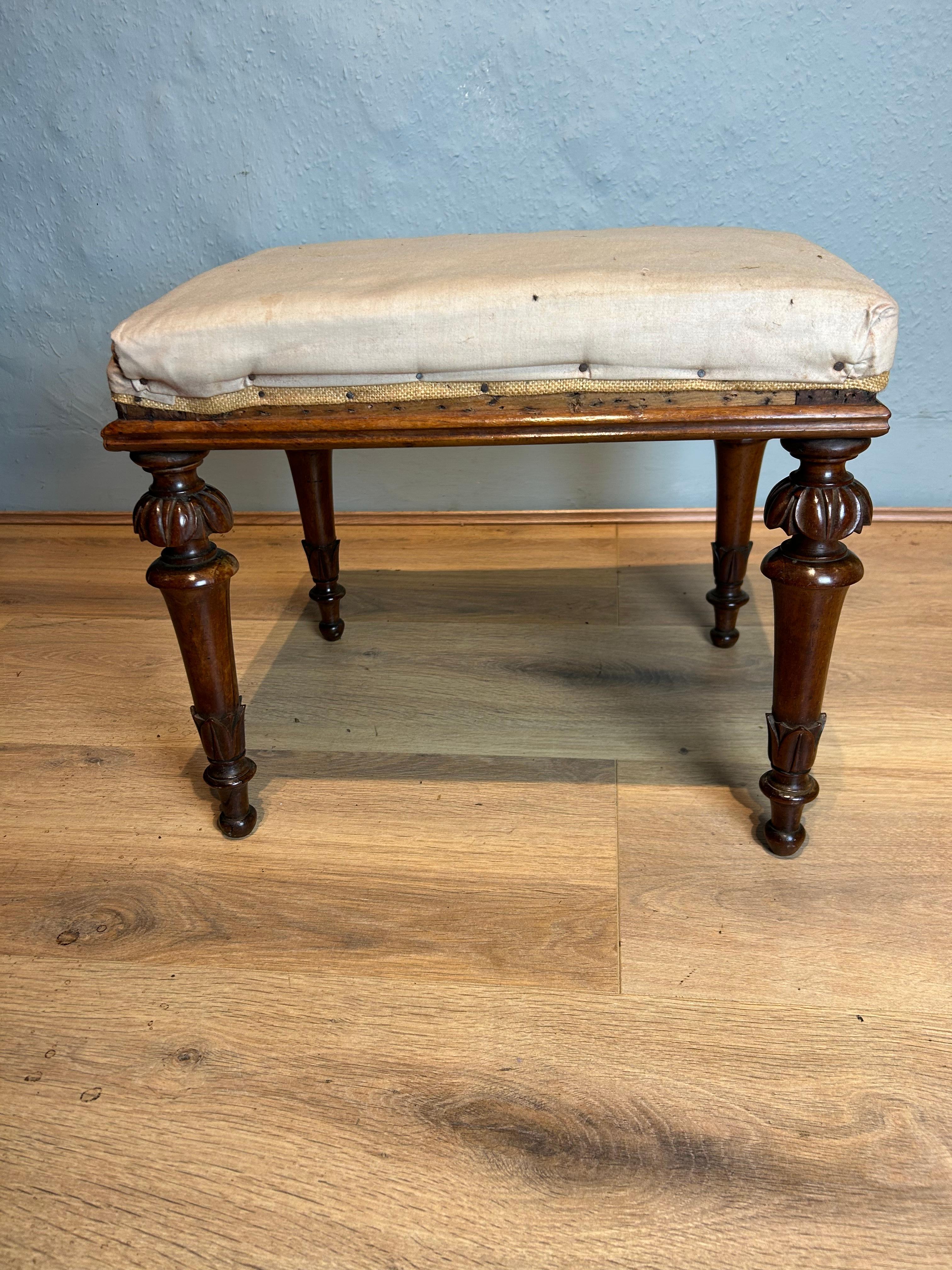 Antique William 4th stool circa 1835 retaining its original upholstery in the calico , the rails lipped with a ogee moulding resting on turned carved acanthus legs.
