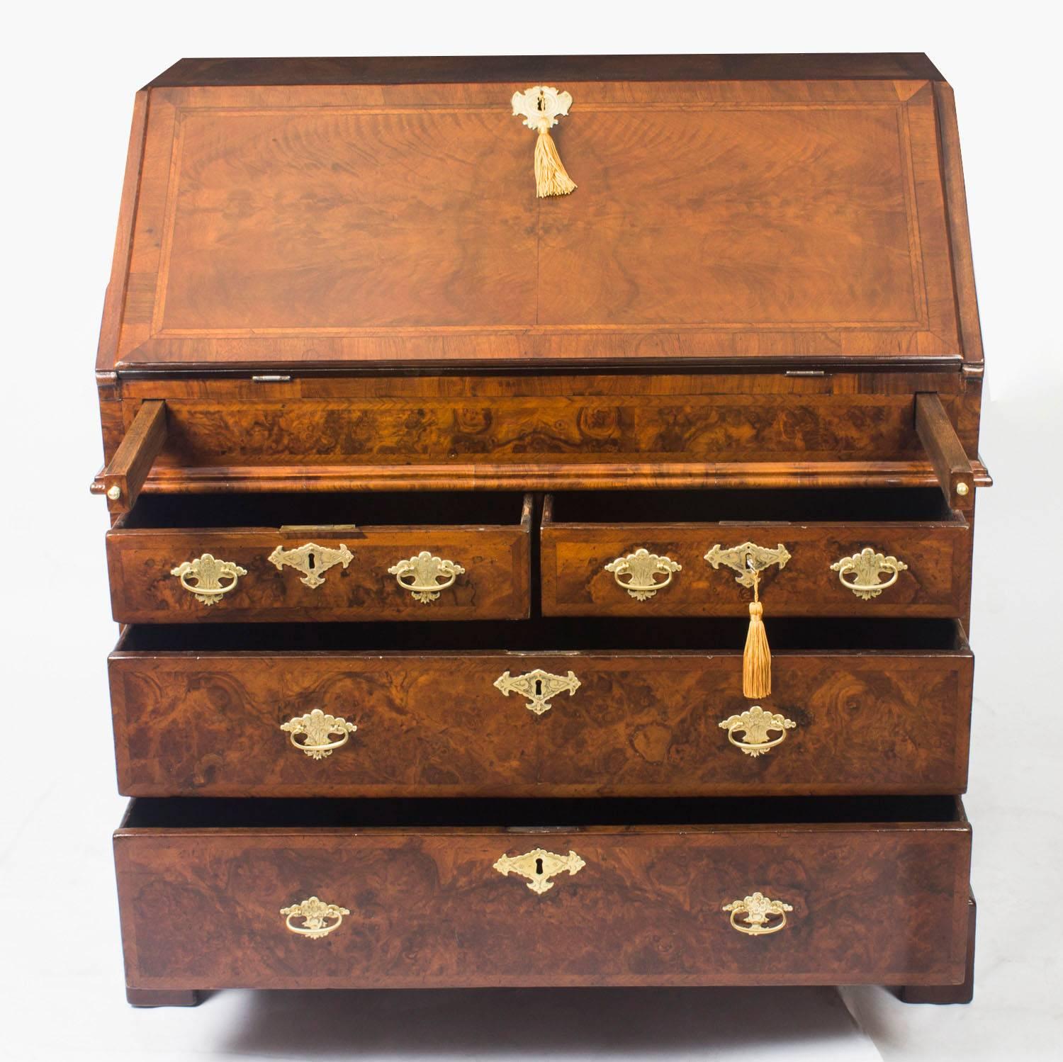 A superb William & Mary burr walnut and feather crossbanded bureau, circa 1690 in date.

The hinged fall enclosing a fitted stepped interior, four small drawers with a central cupboard and secret compartments and a well with sliding