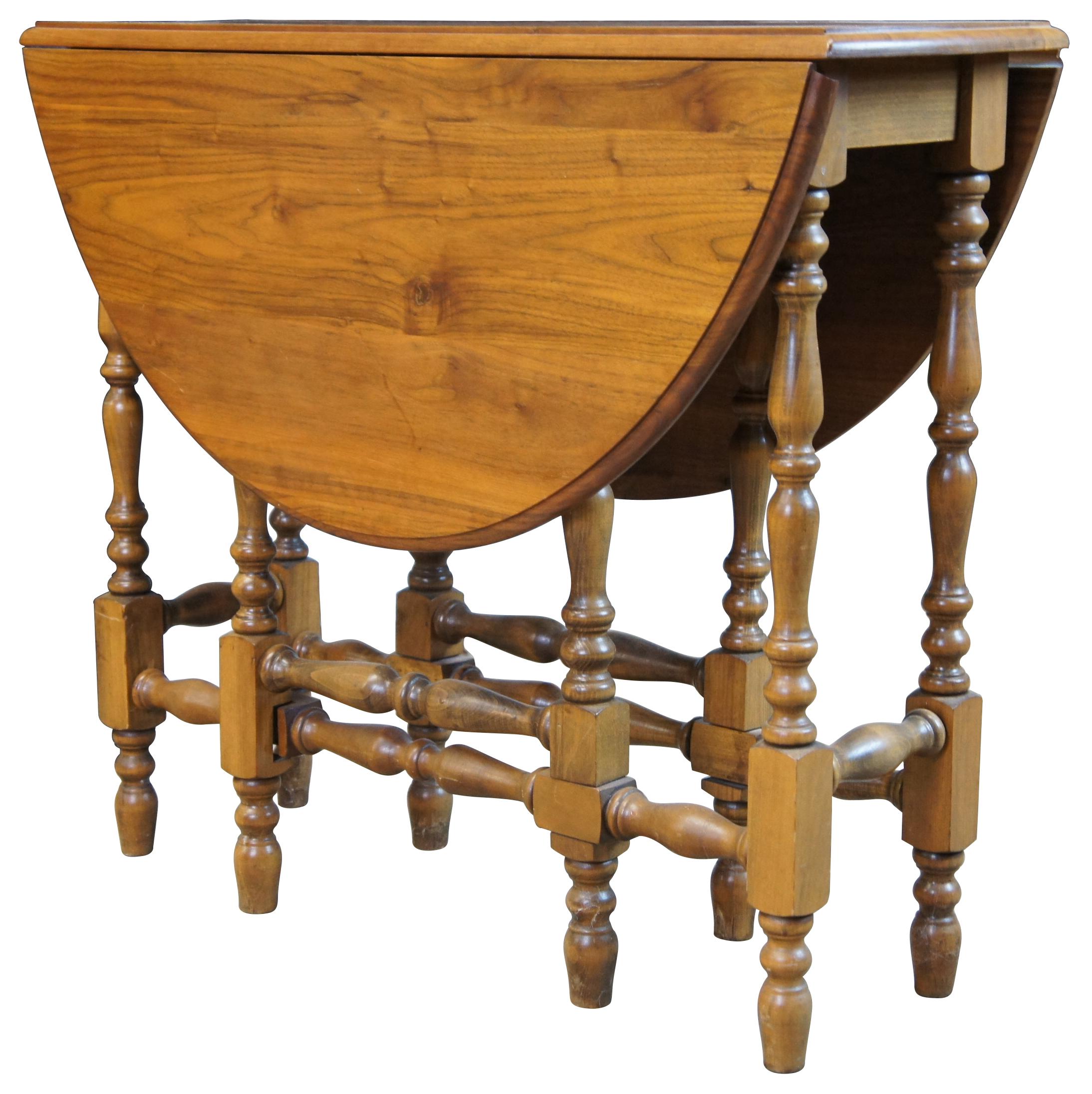 Antique English William & Mary style walnut drop leaf gateleg table featuring oval form with turned legs.

Leaves extend 15