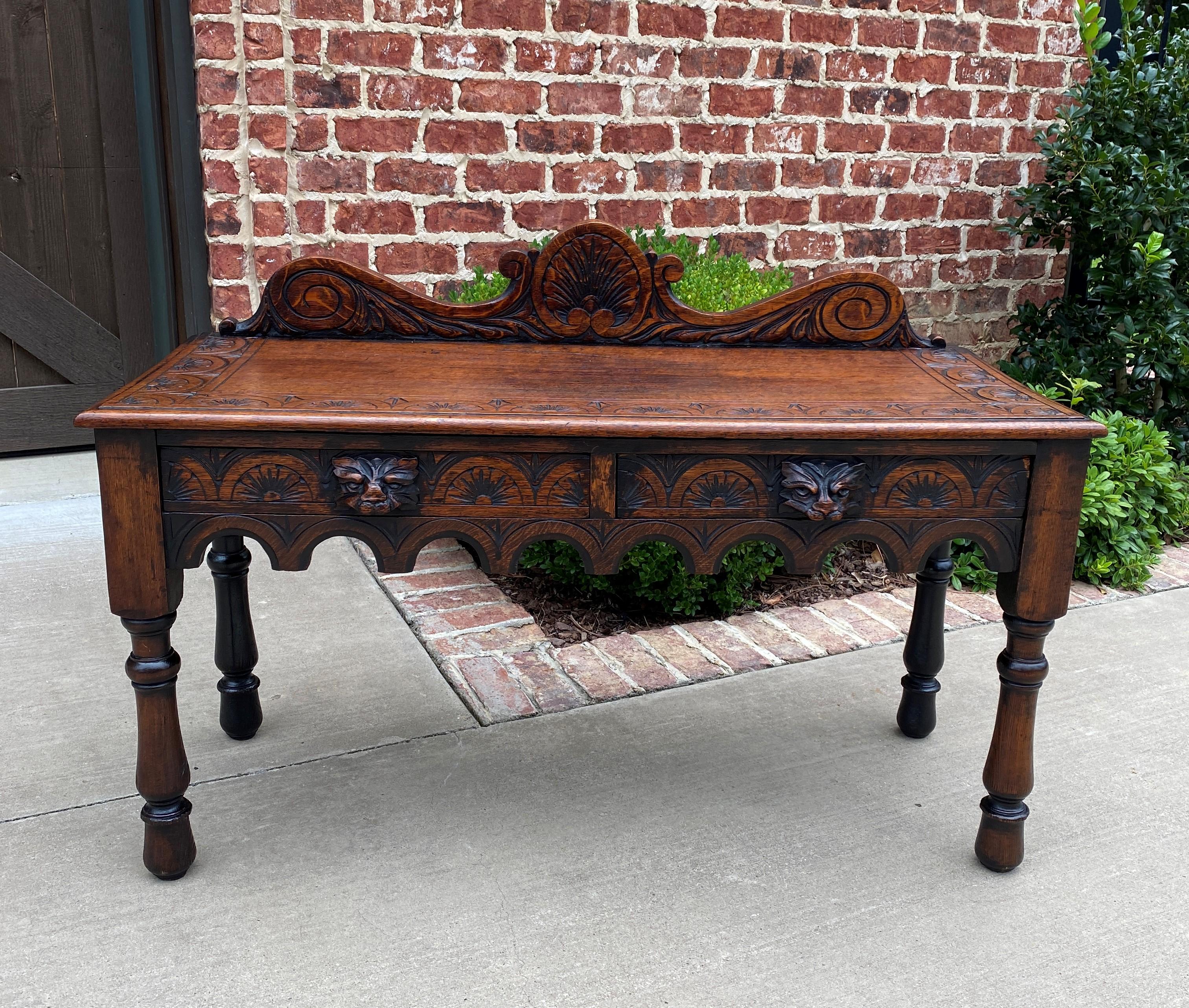 Charming antique English oak window seat or end-of-bed bench~~Gothic Revival~~two drawers ~~c. 1900

Classic British flair decorator piece~~NICELY CARVED with Gothic crown, top and drawer fronts~~two fine, hand-cut dovetailed drawers for