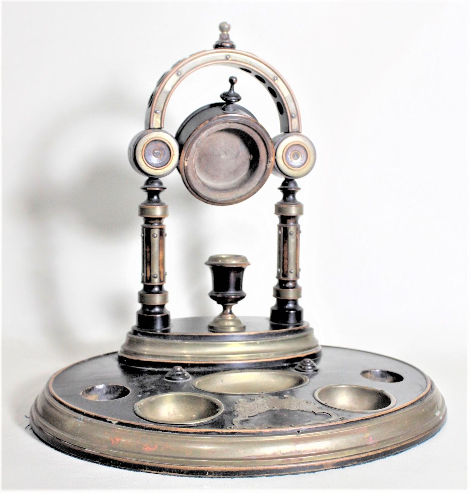 This large wooden dresser top pocket watch stand and vide poche is unmarked, but believed to have been made in England in approximately 1890 in the period Victorian style. The stand is composed of mahogany with a nicely turned stand at the back and