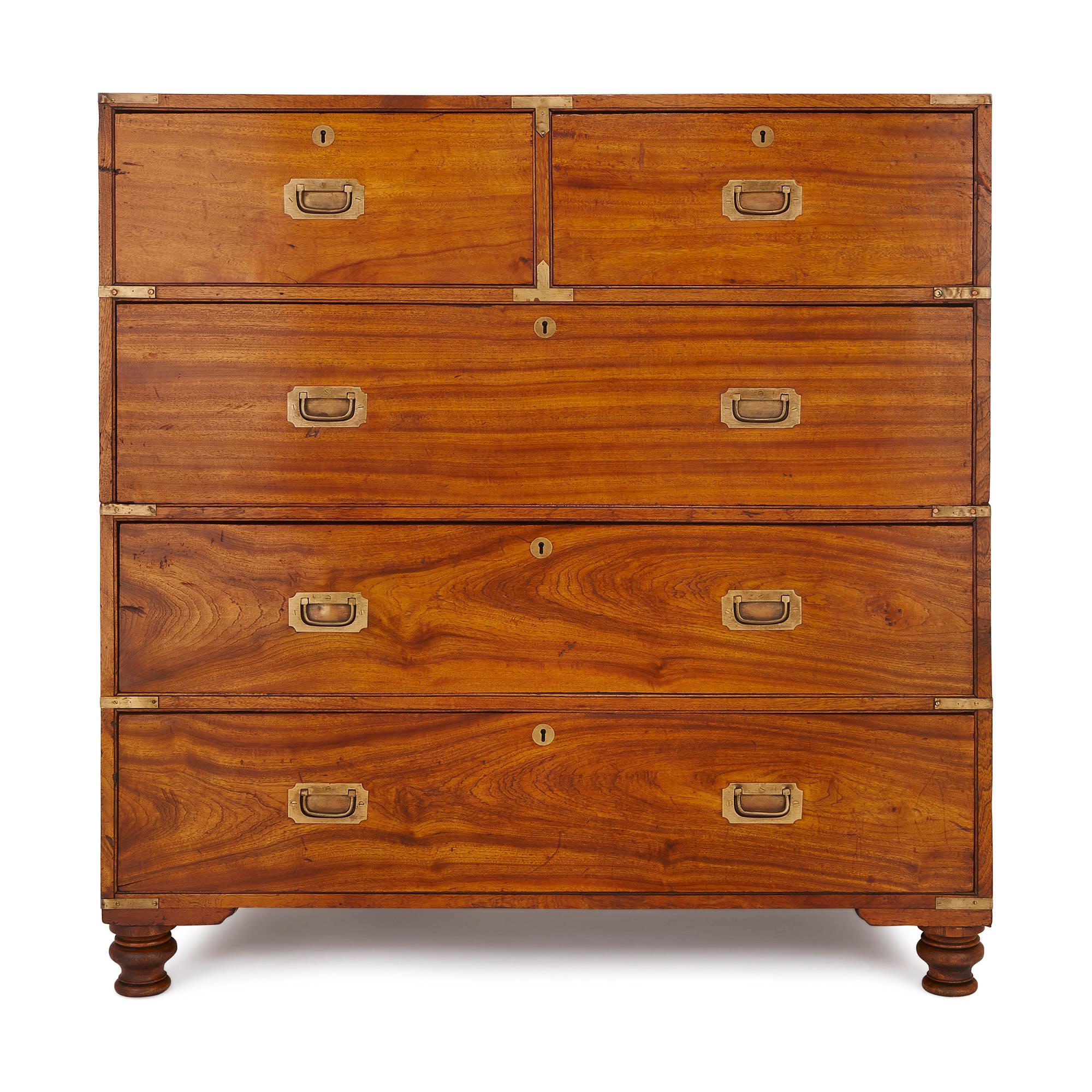 The chest is formed of five drawers, three long beneath two short, placed side by side. The chest is restrained in its style, with simple, sunken brass handles, brass corners and keyholes. On top of this, the the whole thing comes apart in two